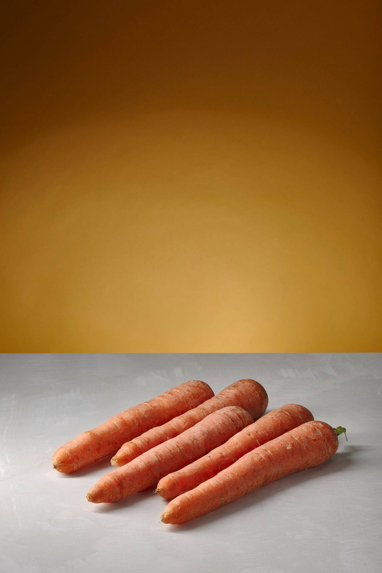 carrots five carrots with white sapienstone top and yellow background
