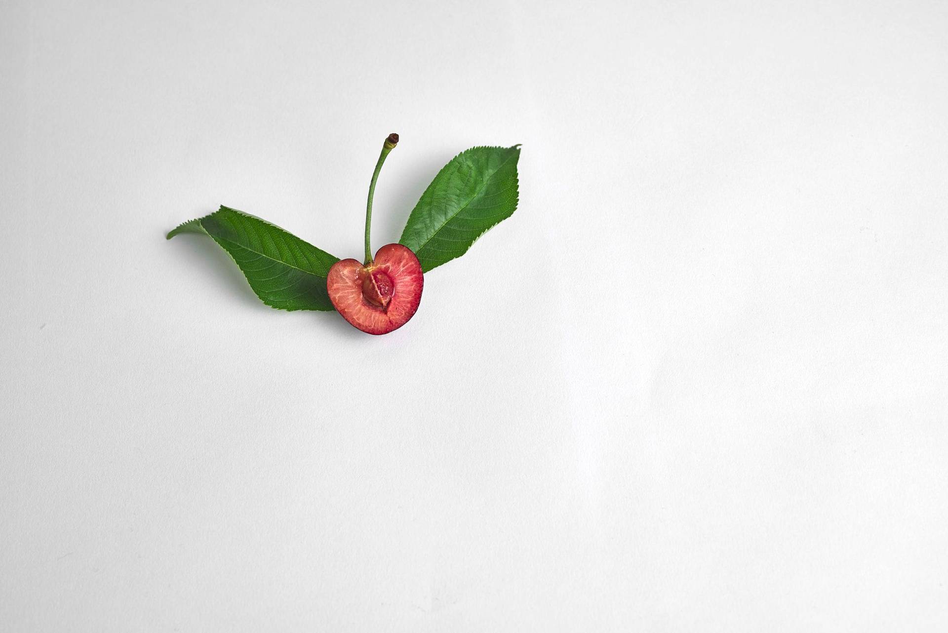 cherry half a cherry with leaves with on white background