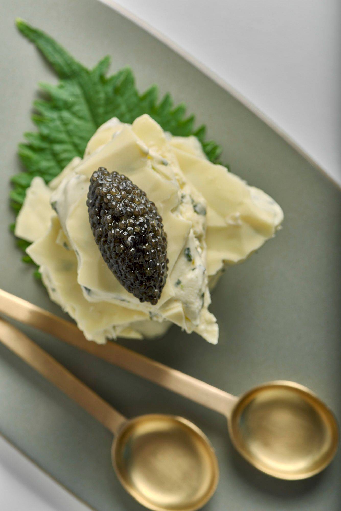 shiso-and-lime-ice-cream-sandwich-with-caviar-and-white-chocolate shiso and lime ice cream sandwich with caviar and white chocolate on a gray plate with white background