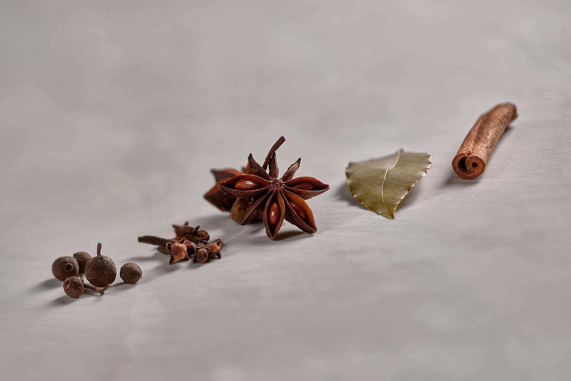 allspice-cloves-star-anise-bay-leaf-and-cinnamon allspice cloves star anise bay leaf and cinnamon on white sapienstone top