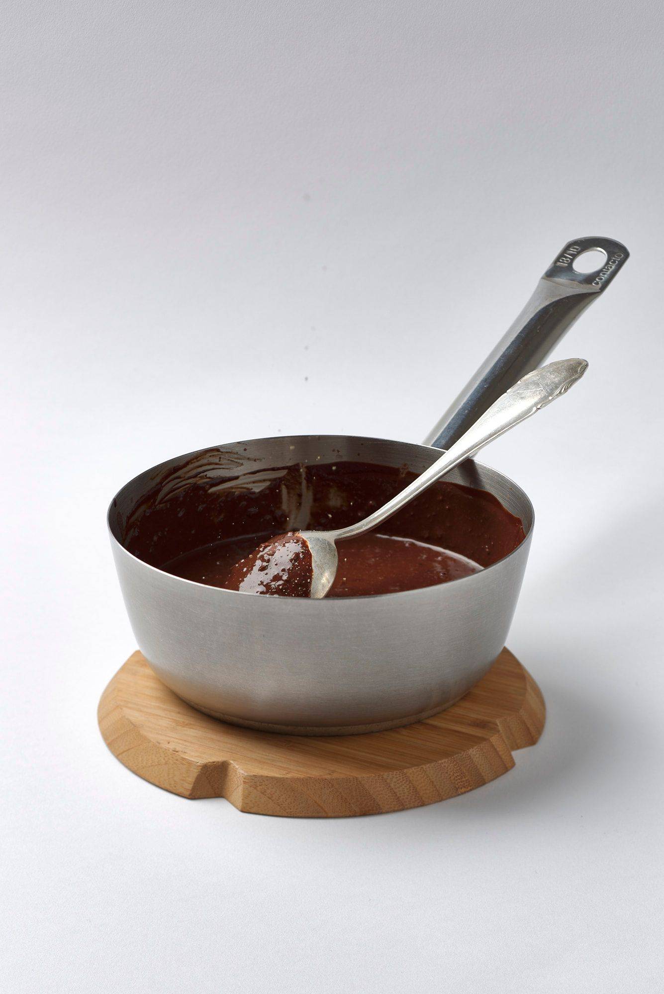 mole-sauce mole sauce in a sauce pan with white background