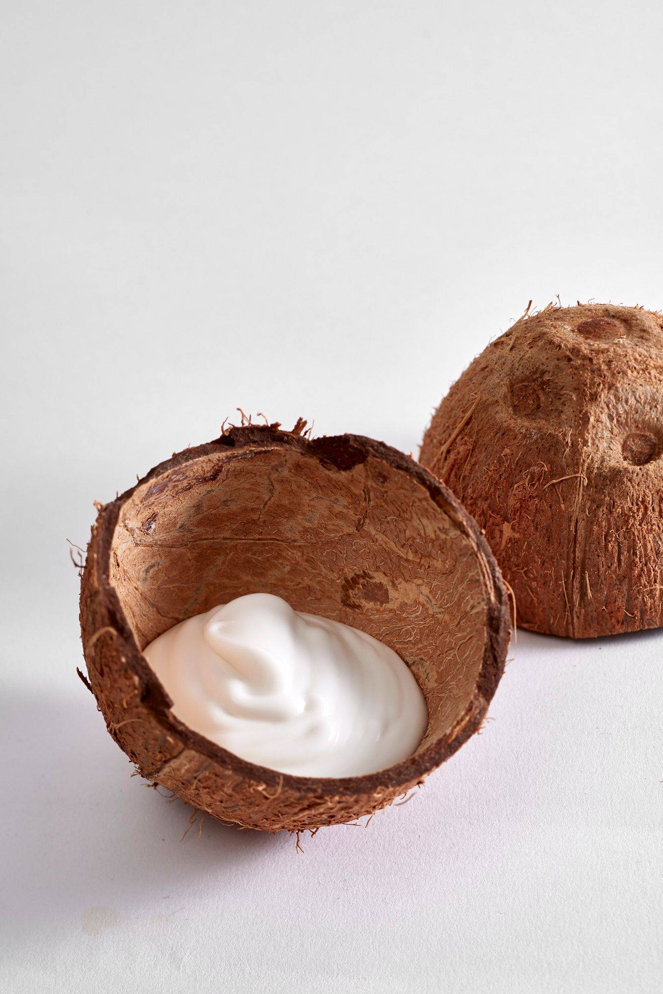 coconut-cream coconut cream in a coconut shell on white background