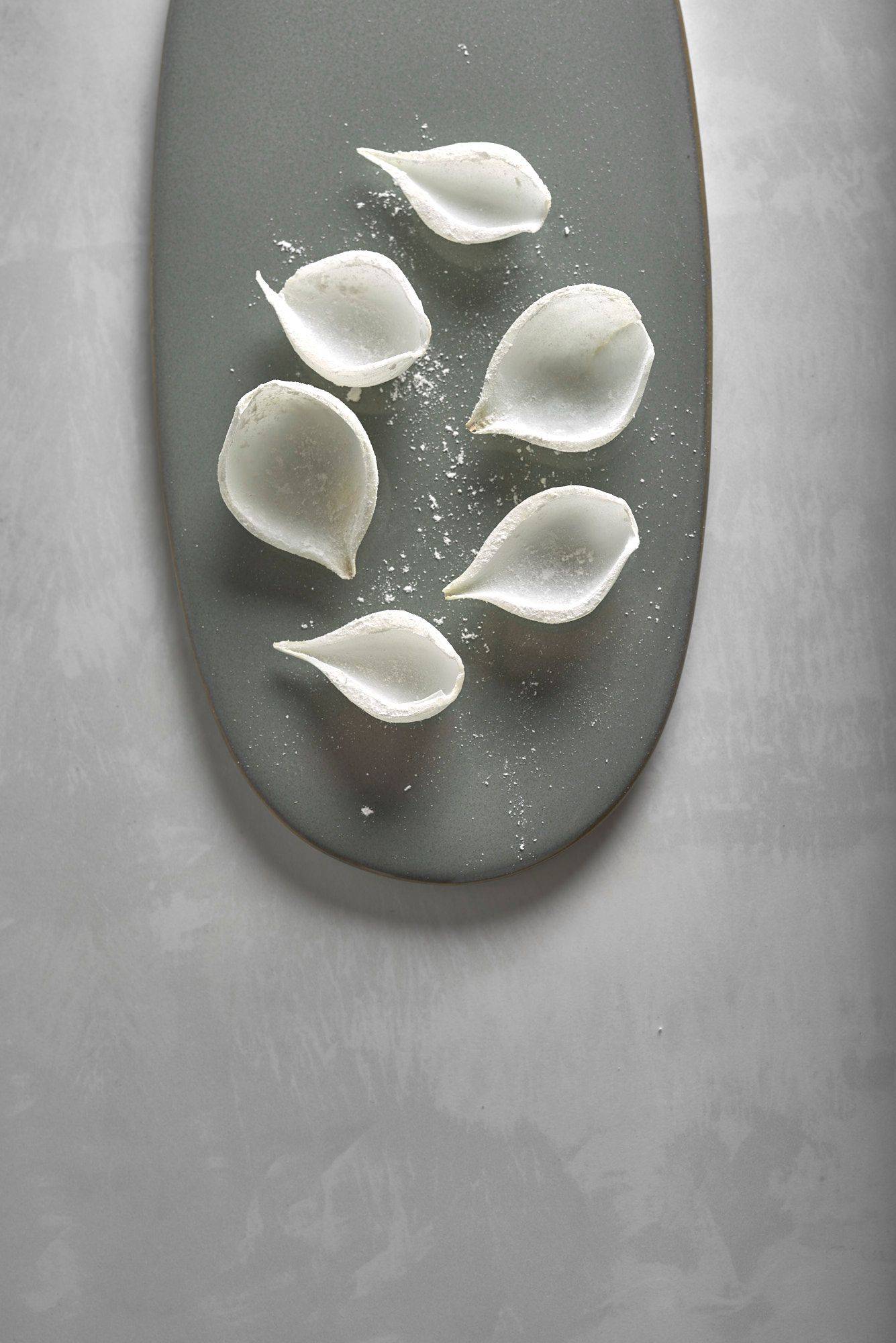 floured-onions flour tossed onions on a gray plate on a white stone table
