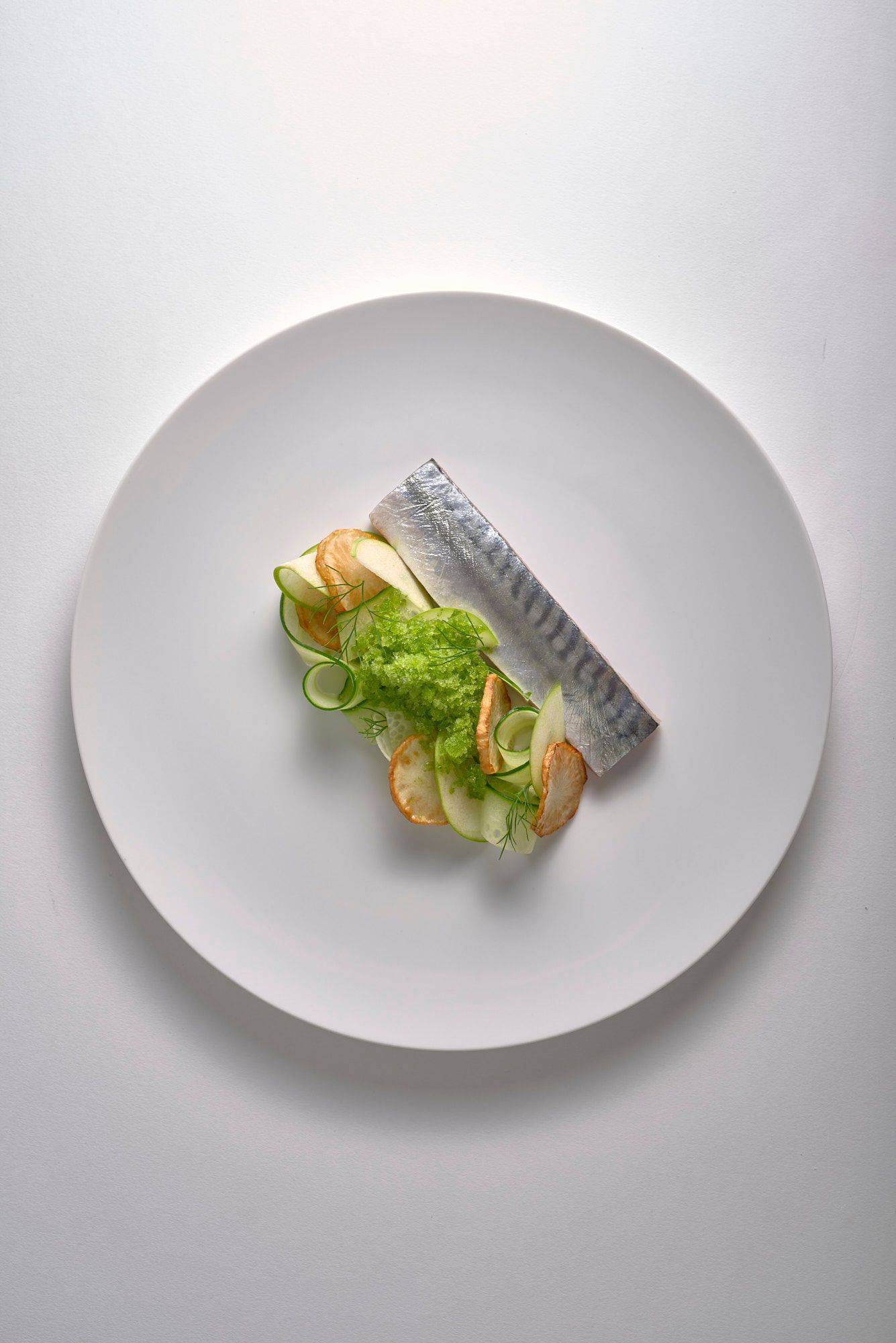 cured-mackerel-with-jerusalem-artichokes-and-dill-granita cured mackerel with jerusalem artichokes and dill granita on a white plate with white background