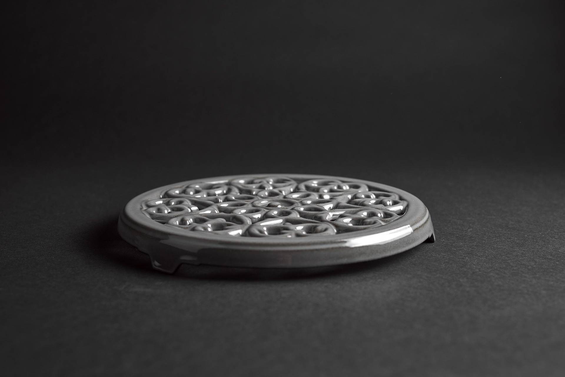 staub-la-cocotte-cast-iron-pots gray staub la cocotte cast iron coaster on black background