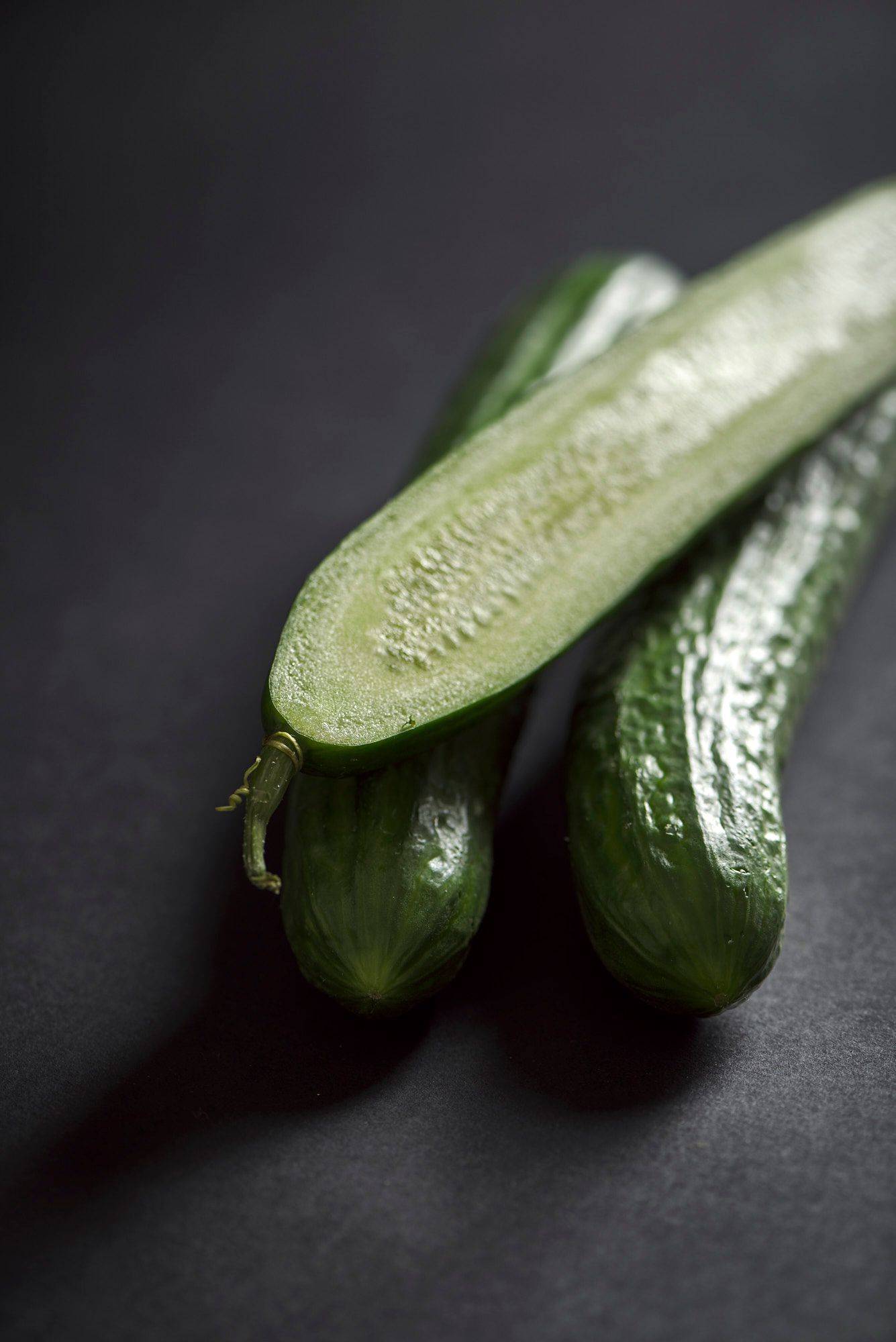 cucumbers three cucumbers on black background