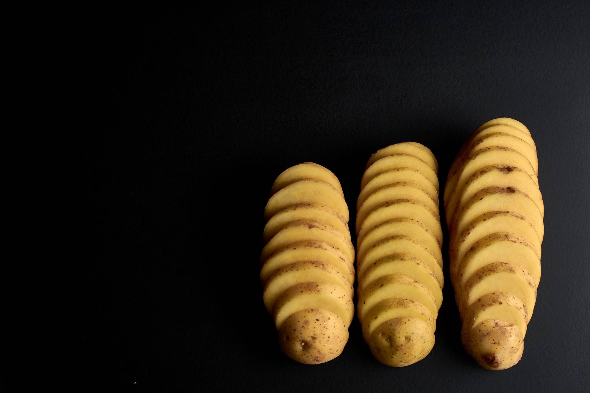 sliced-potatoes sliced potatoes on black background