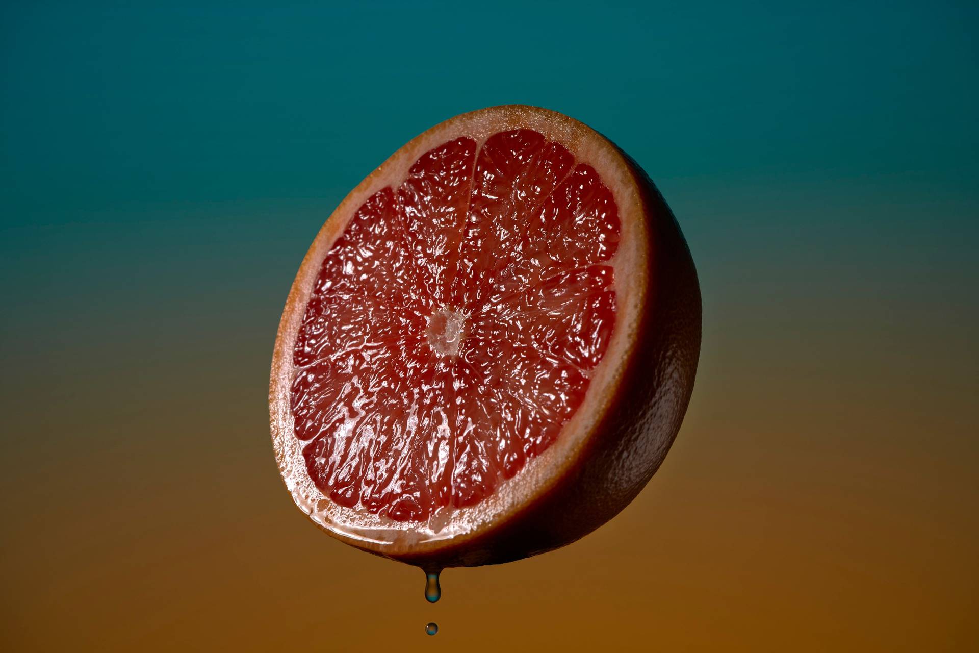 pink-grapefruit pink grapefruit on blue and orange background