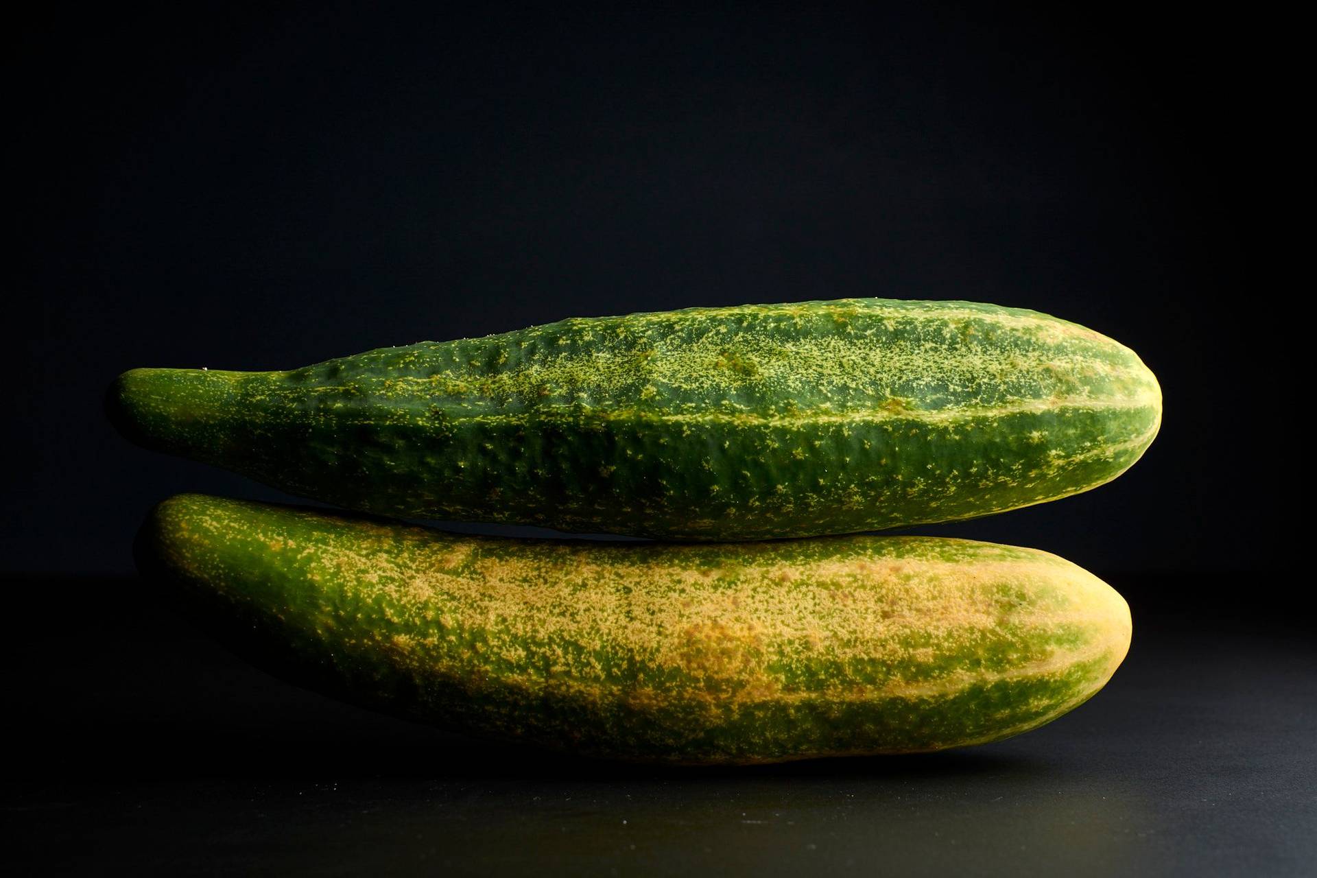 cucumbers two cucumbers on black background