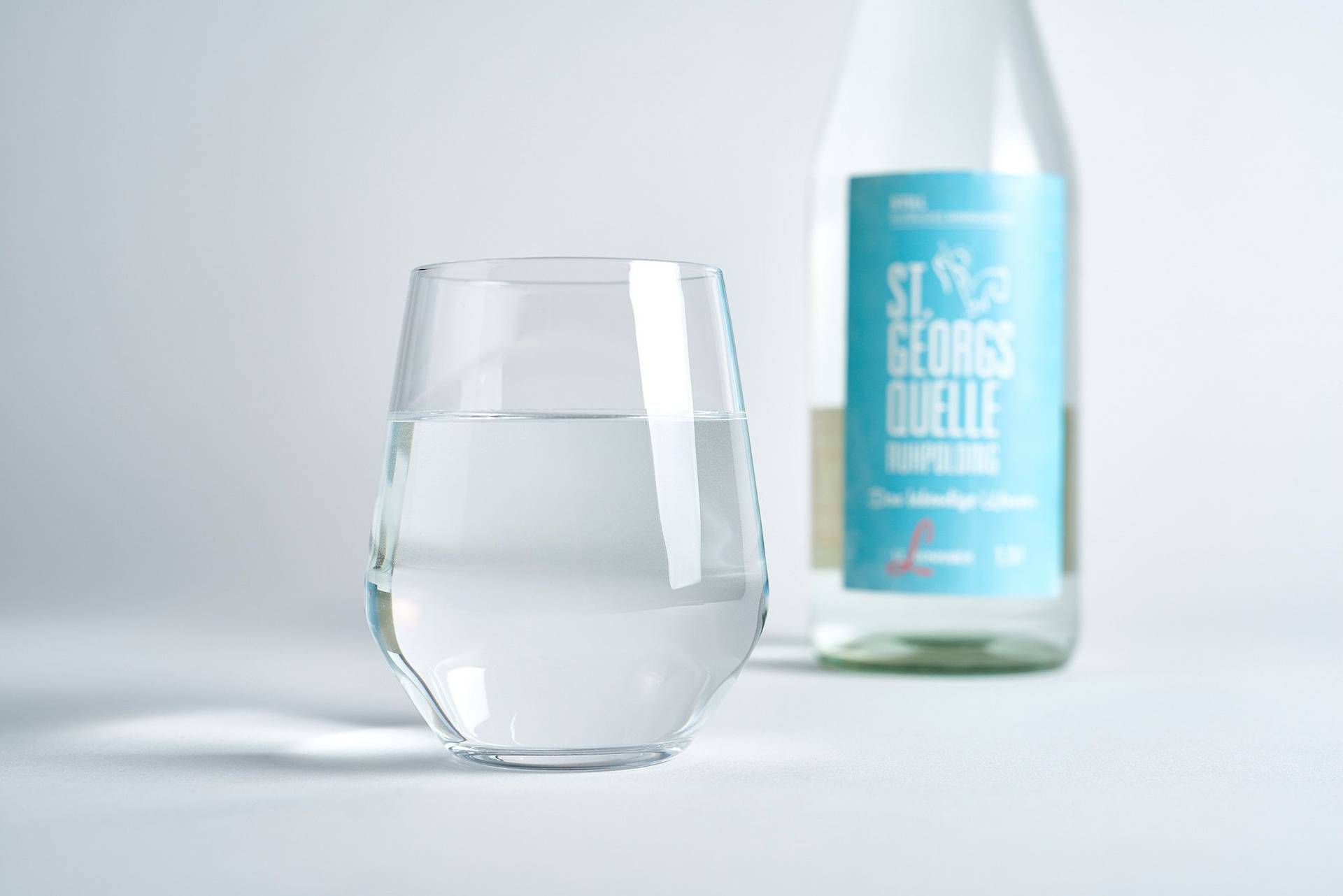 mineral-water mineral water bottle and glass on white background