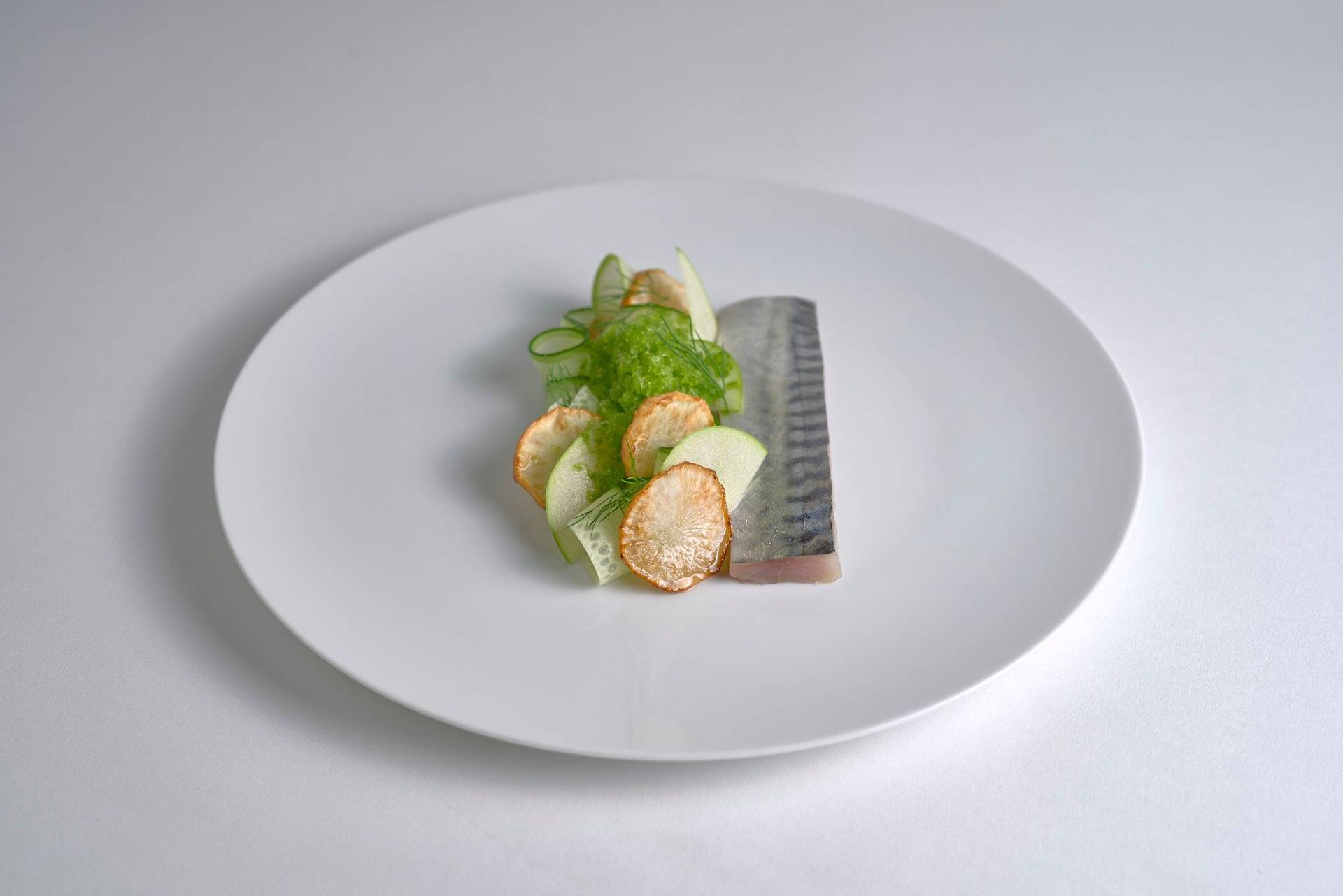 cured-mackerel-with-jerusalem-artichokes-and-dill-granita cured mackerel with jerusalem artichokes and dill granita on a white plate with white background