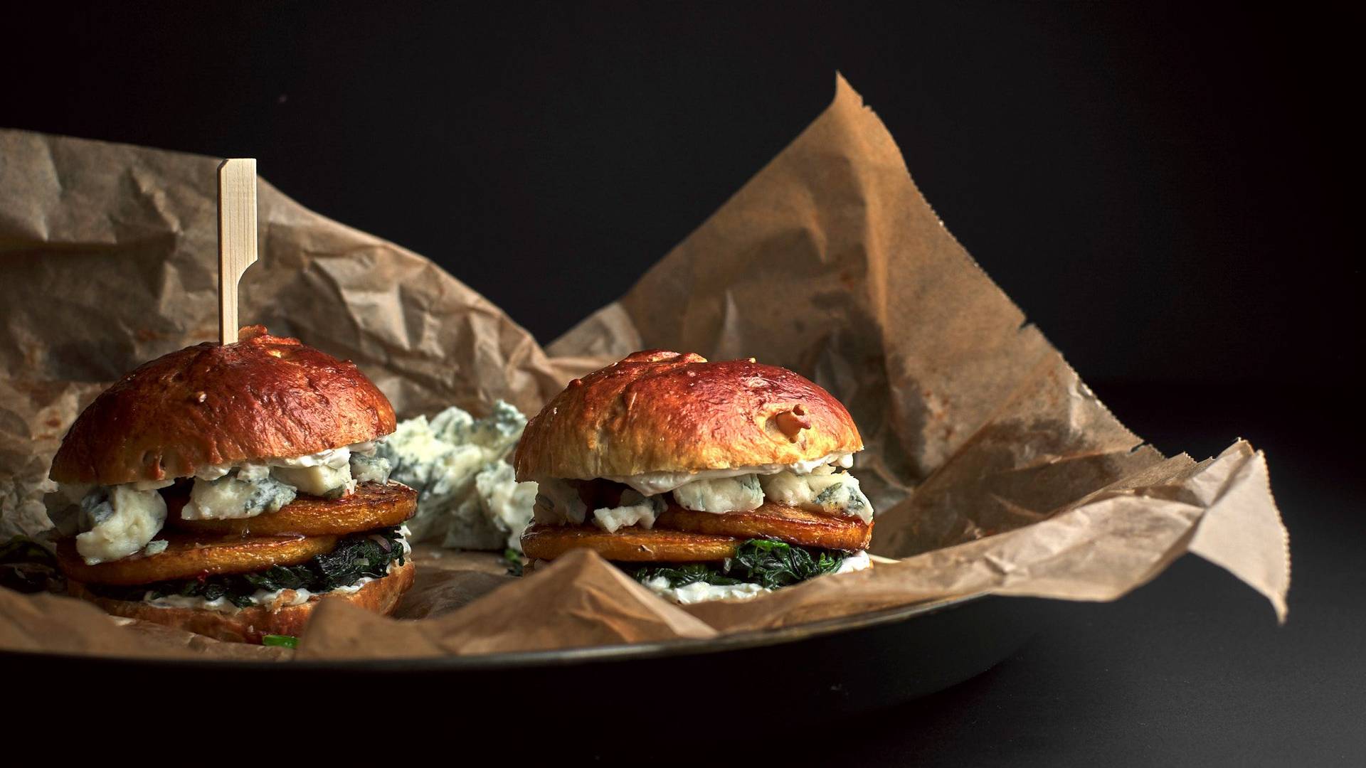pumpkin-brioche-burger-with-blue-cheese pumpkin-brioche burger with blue cheese and spinach with black background