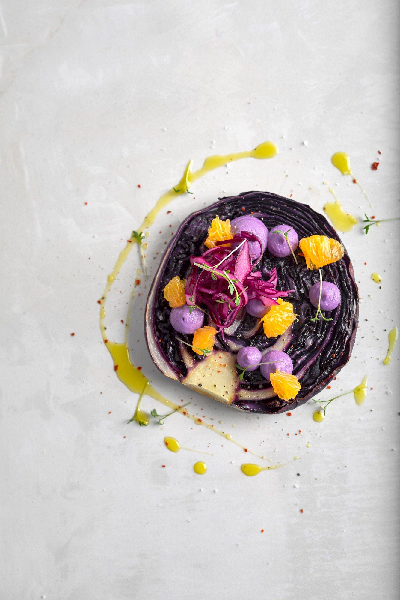vegan-red-cabbage-steak-with-cashew-cream-and-tangerines vegan red cabbage steak with cashew cream and tangerines on a white sapienstone top
