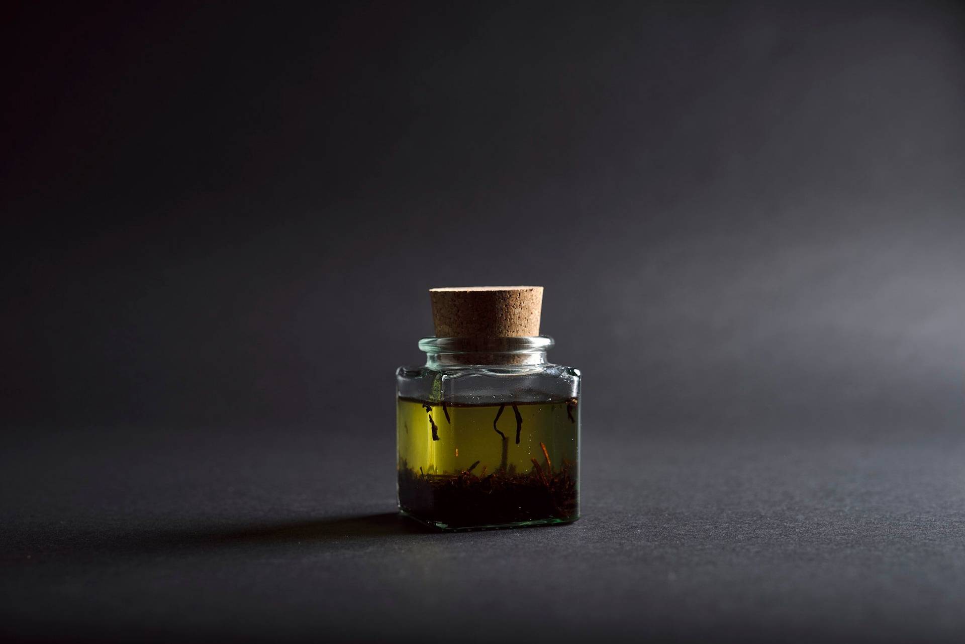 tea-oil tea oil in a glass with black background