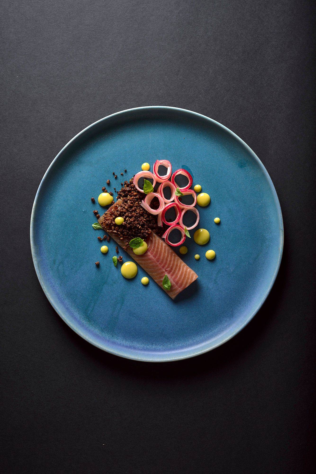 basil-and-orange-cured-char-with-rhubarb-and-tea-mayonnaise basil and orange cured char with rhubarb and tea mayonnaise on a blue plate with black background