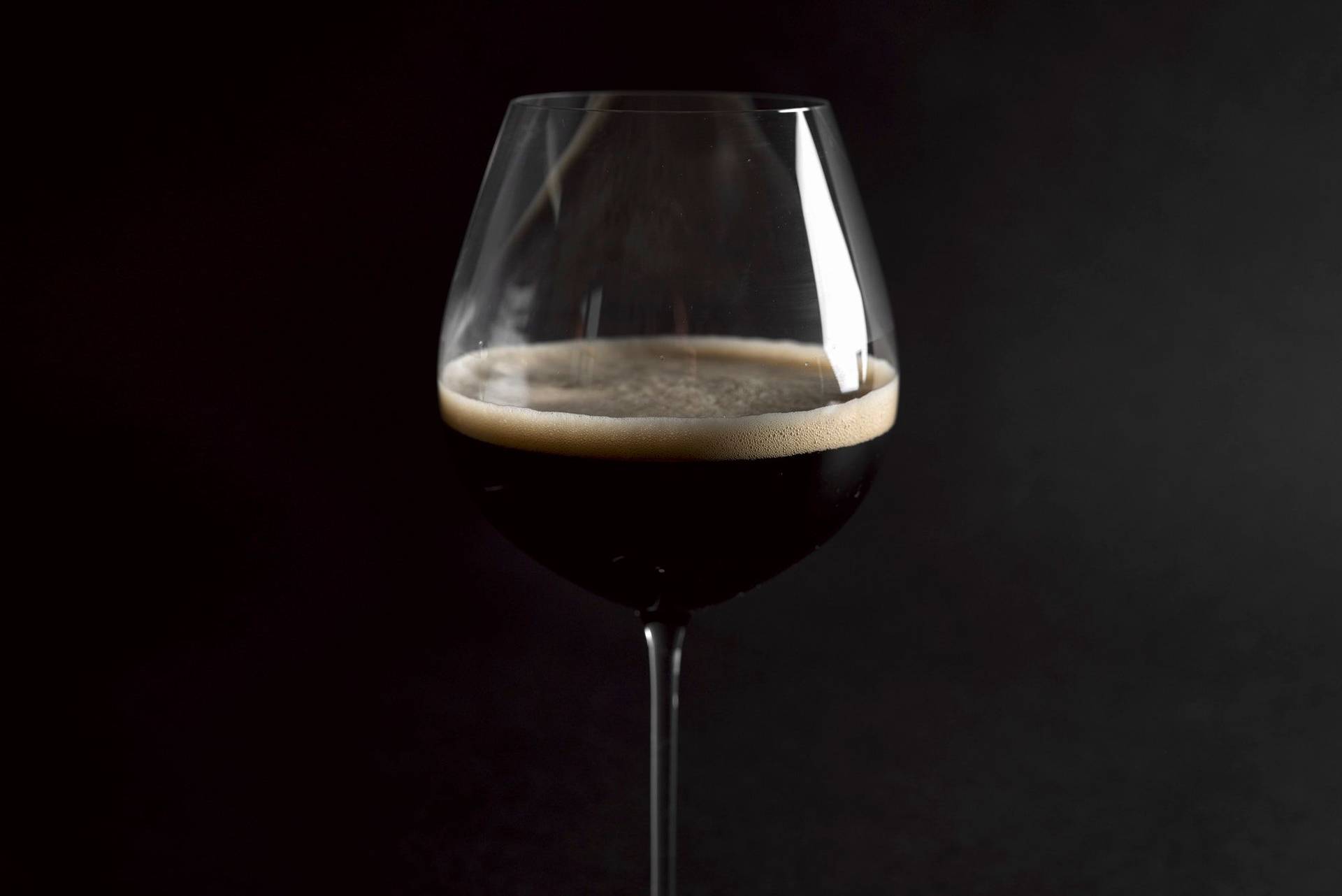 dark-beer a glass of dark beer with black background