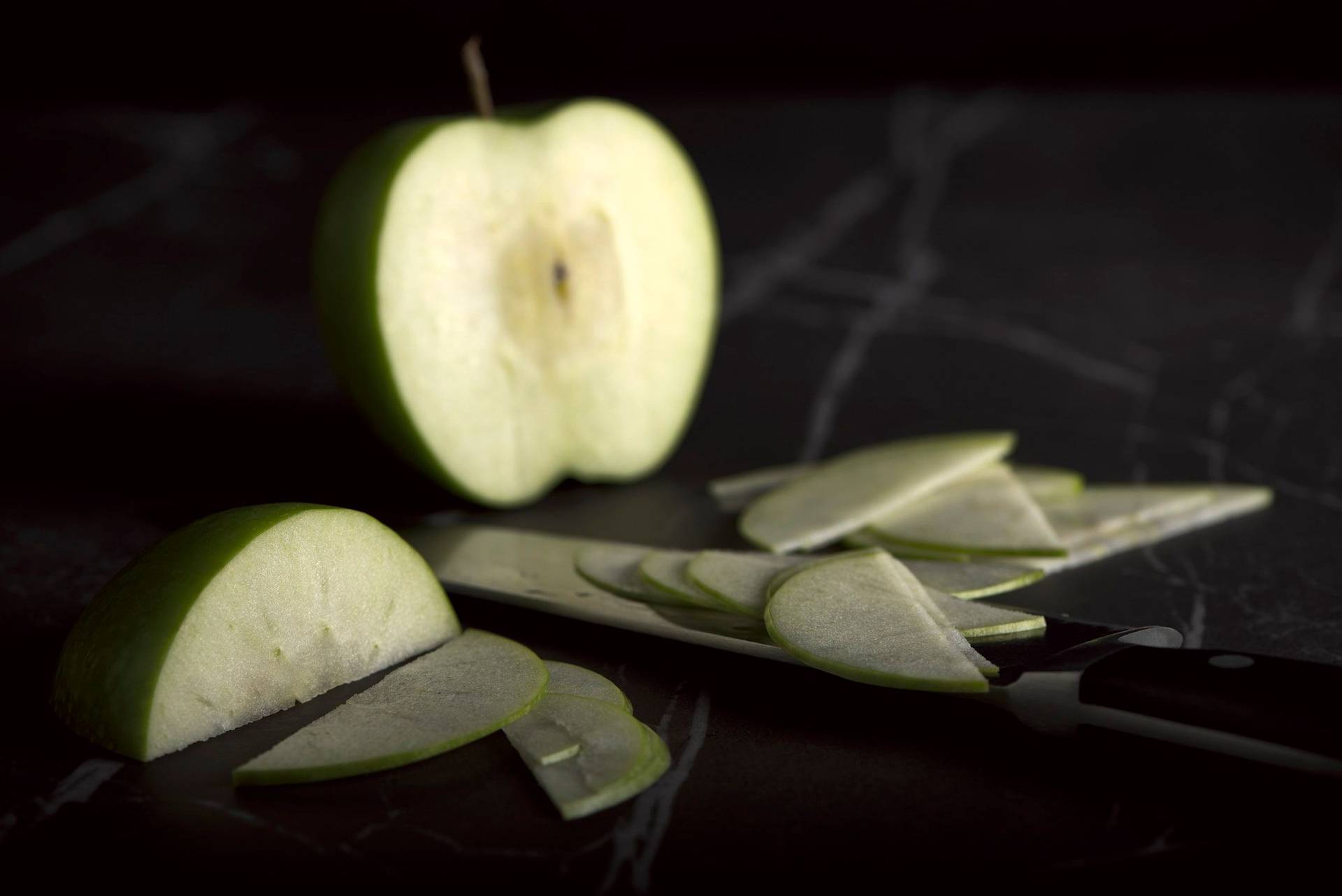 green-apple a green cut apple on a gray sapienstone top