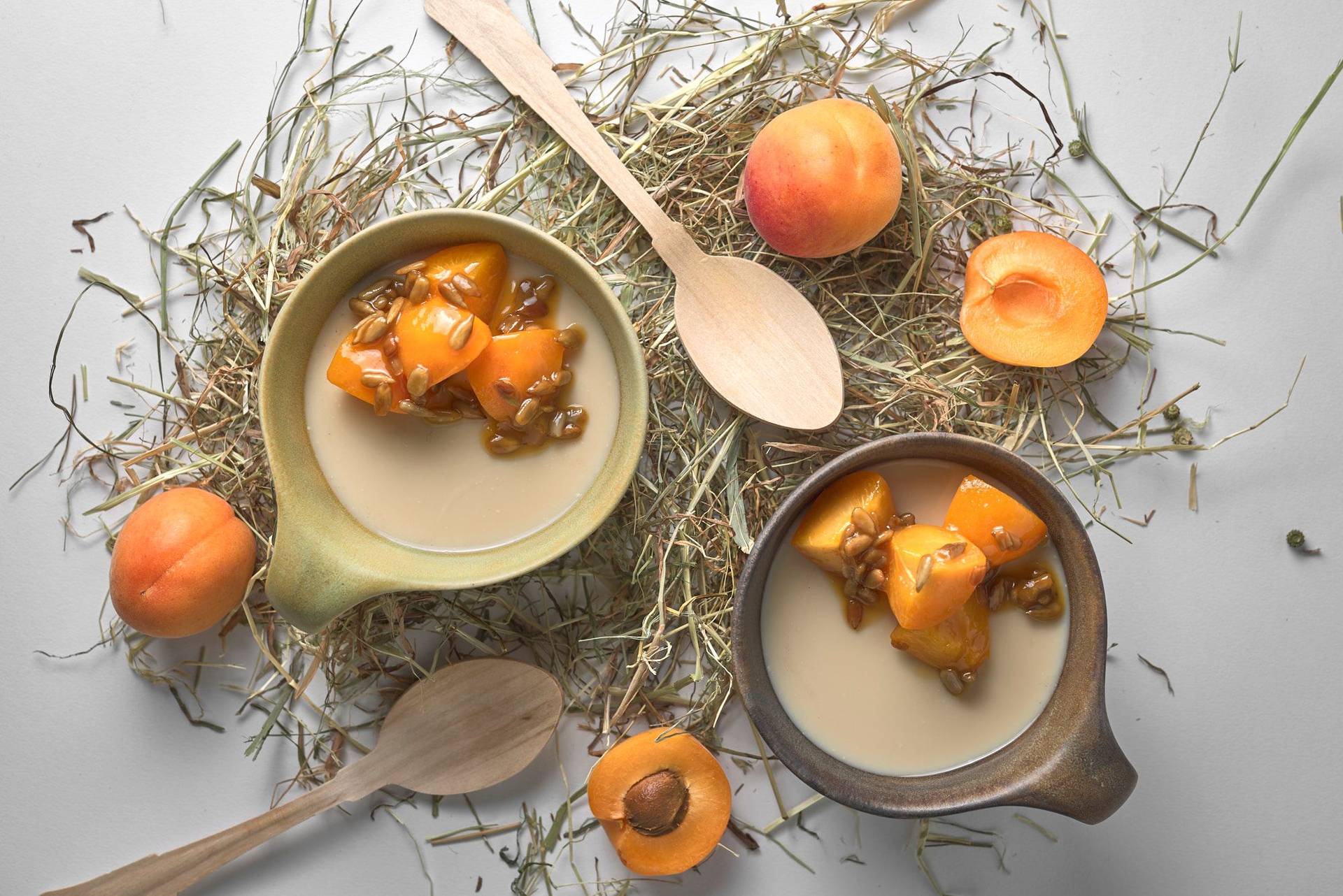 hay-panna-cotta-with-apricots-and-sunflower-seeds hay panna cotta with caramelized apricots and sunflower seeds on white background
