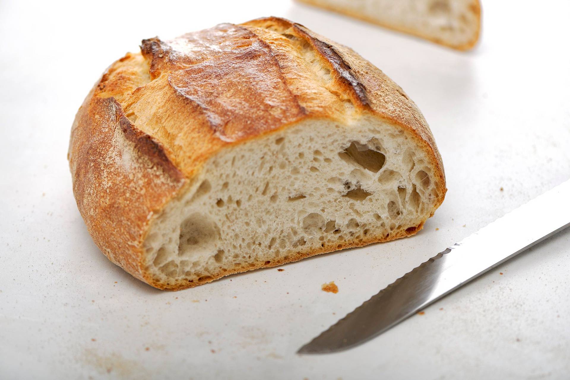 white-sourdough-bread a loaf of white sourdough bread on a white sapienstone top