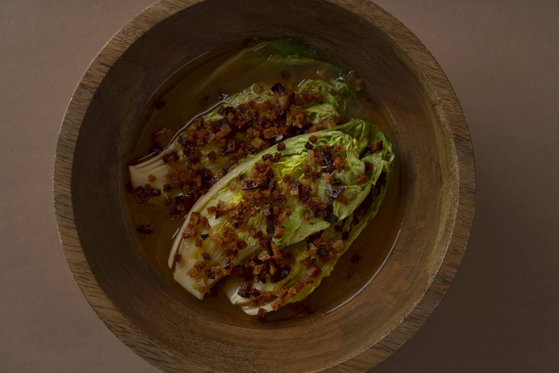 romaine-lettuce-with-miso-broth-and-sourdough romaine lettuce with miso broth and sourdough in a wooden bowl with brown background