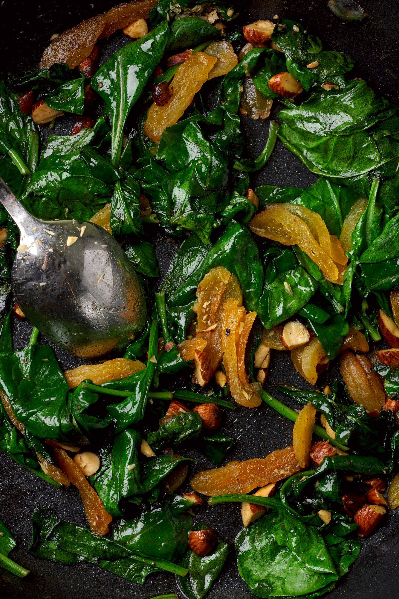 sauteed-spinach sauteed spinach with apricots and smoked almonds in a pan