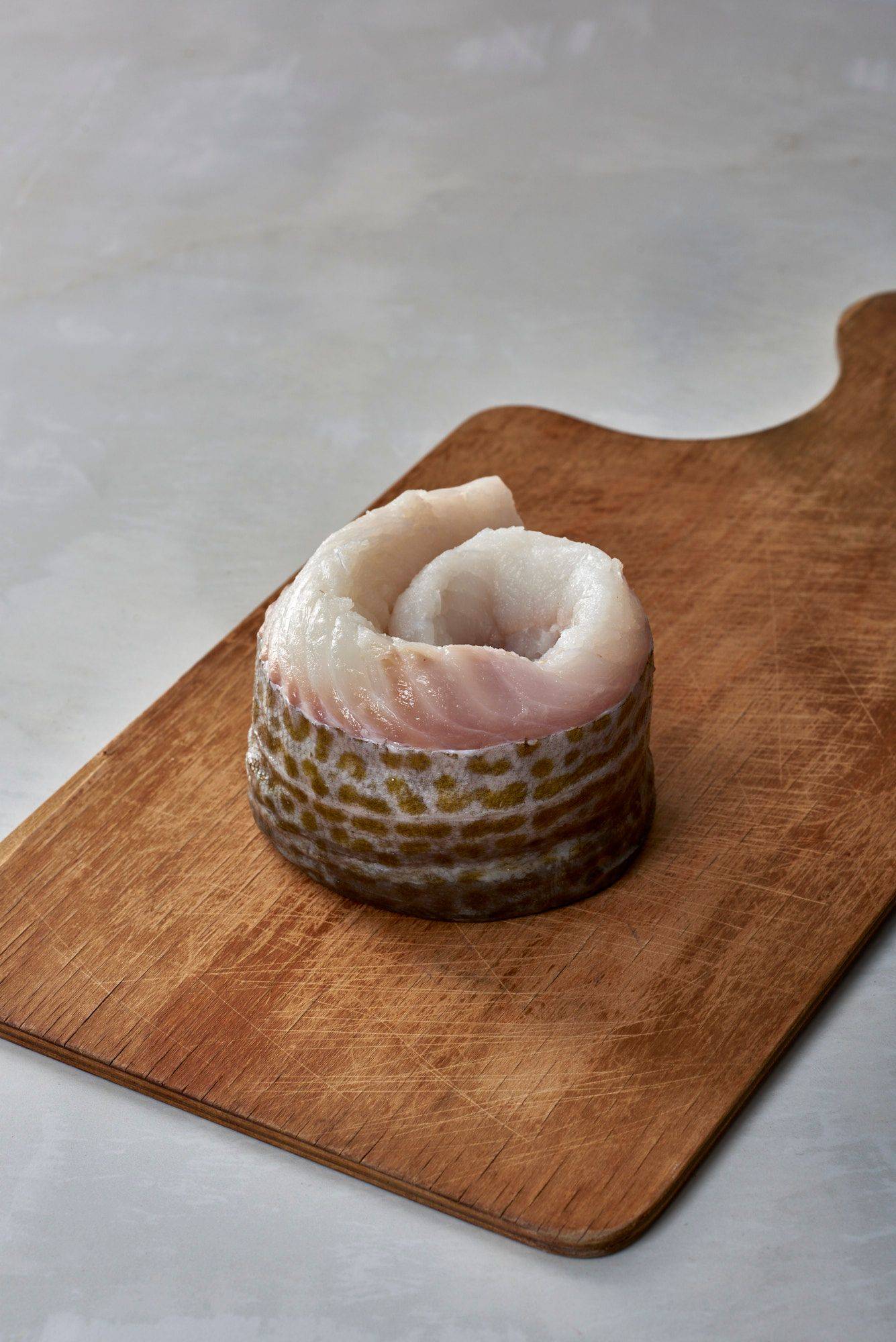 cod-fish-fillet cod fish fillet on a wooden board with white sapienstone top