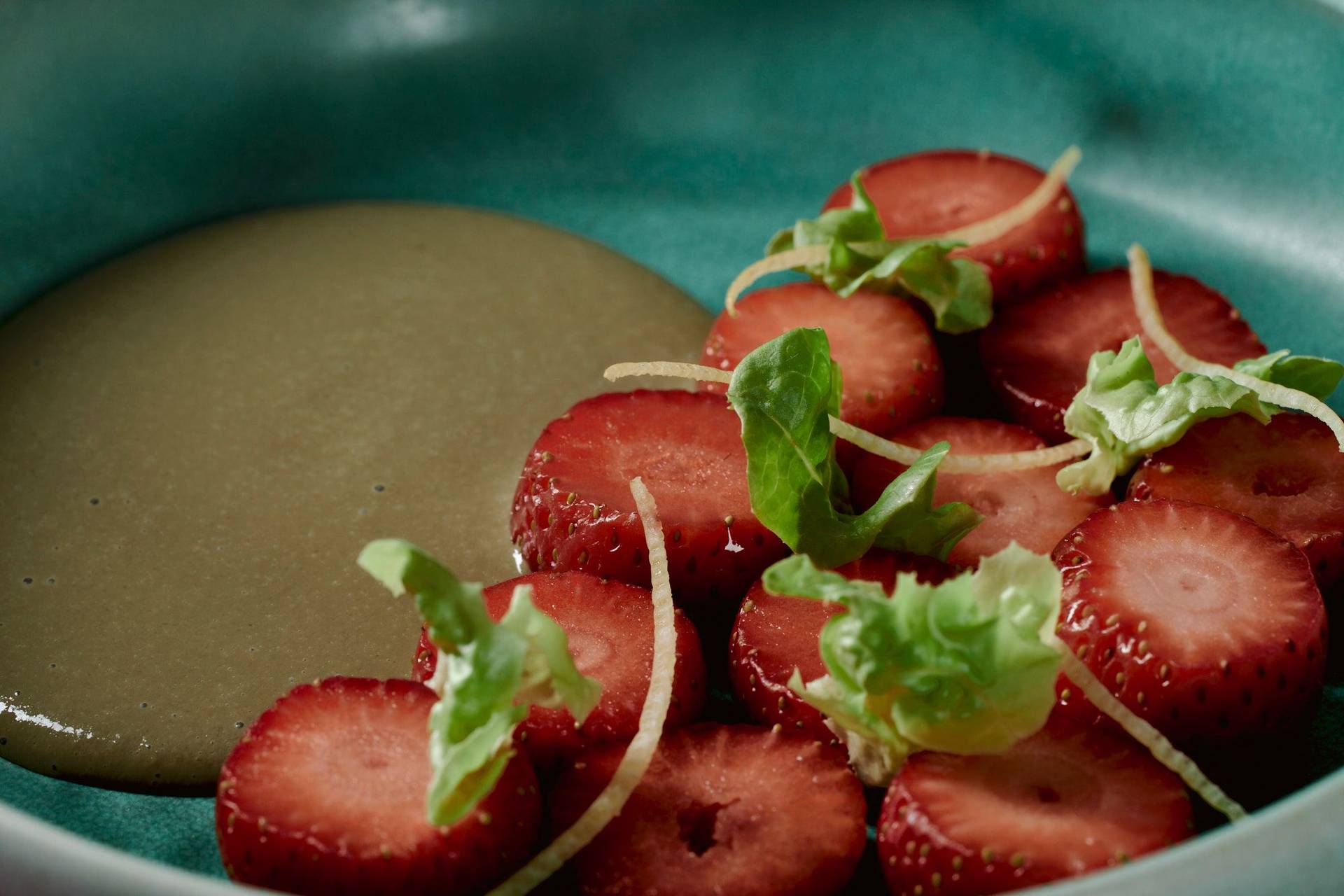 vegan-strawberry-dessert-with-lettuce-and-sunflower-seeds vegan strawberry dessert with lettuce and sunflower seeds on a turquoise plate