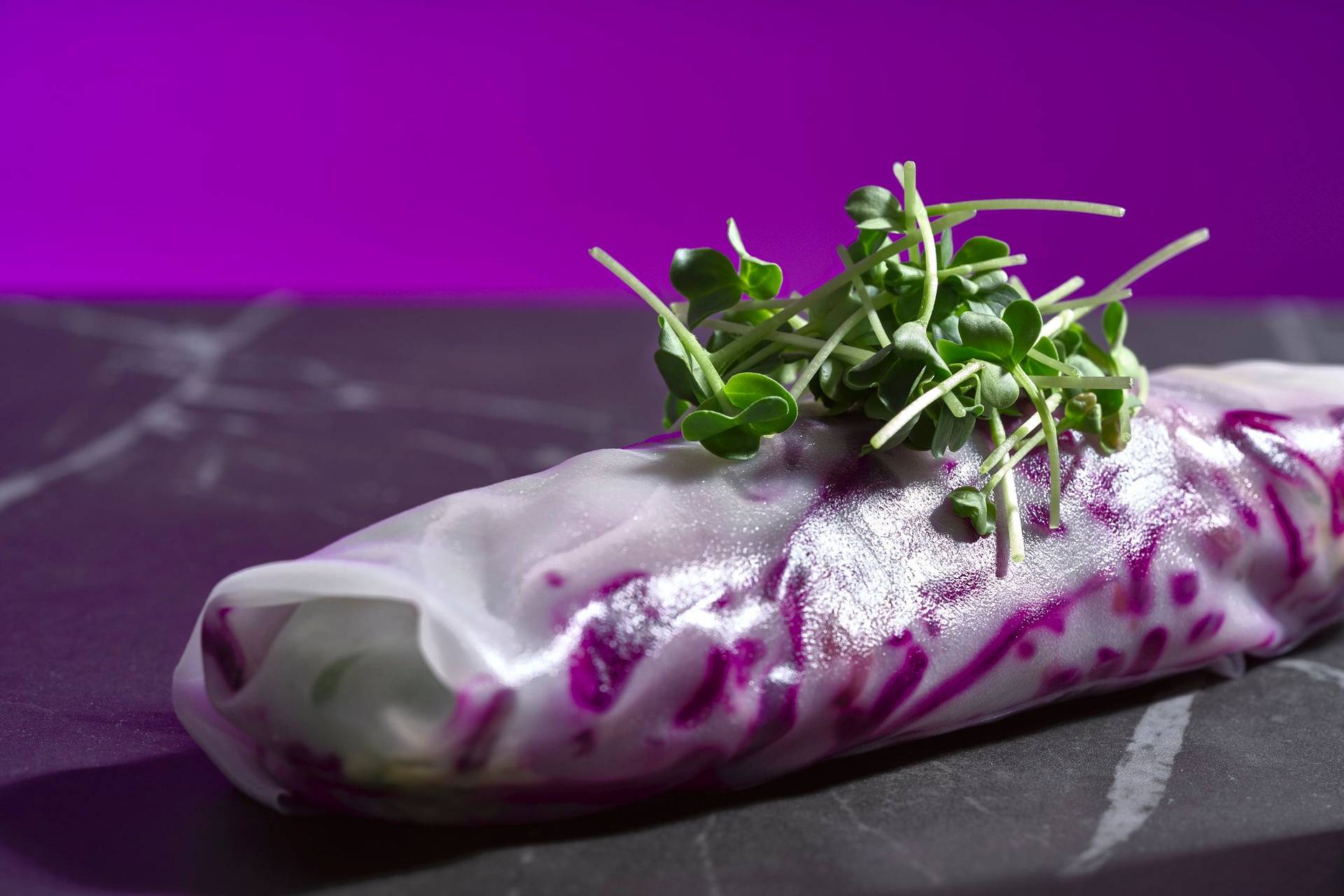 christmas-summer-rolls-with-red-cabbage-tangerine-salad-and-chicken-liver christmas summer rolls with red cabbage tangerine salad and chicken liver on a gray marbled sapienstone top with purple background