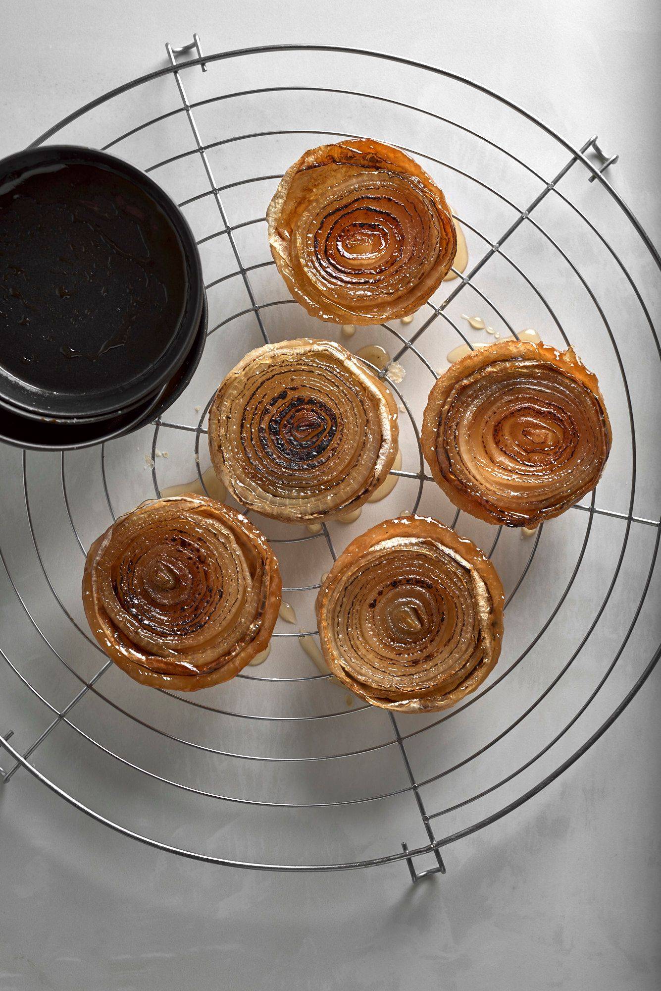 baked-onion-tarte-tatin five baked onion tarte tatins on a white stone table
