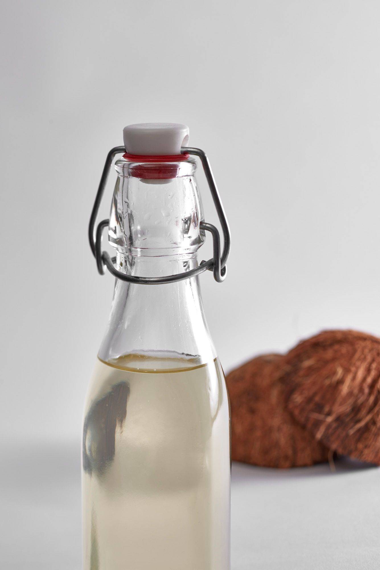 coconut-syrup coconut syrup in a glass bottle on white background