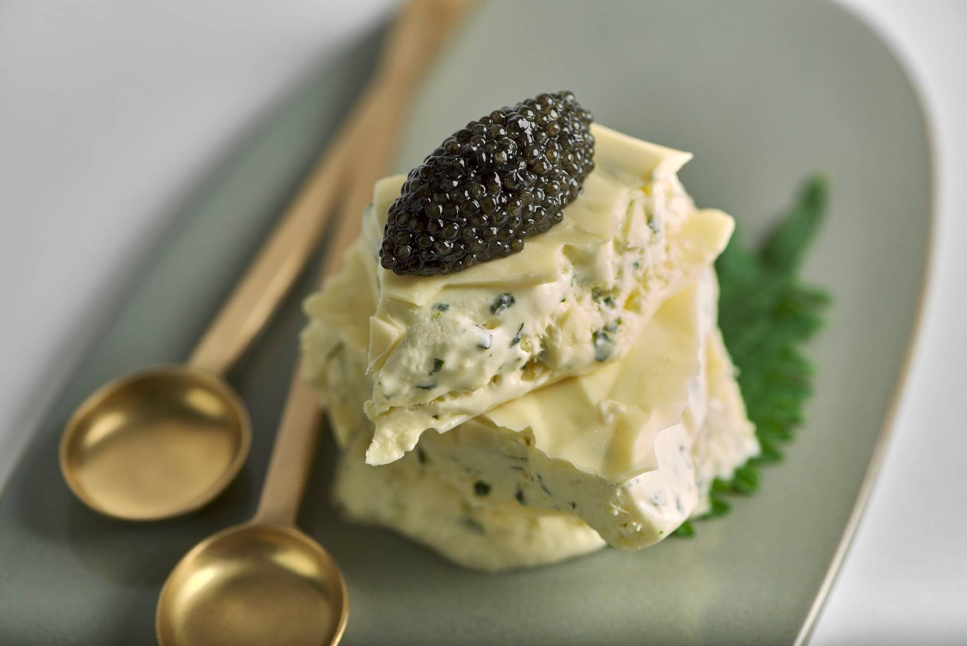 shiso-and-lime-ice-cream-sandwich-with-caviar-and-white-chocolate shiso and lime ice cream sandwich with caviar and white chocolate on a gray plate with white background
