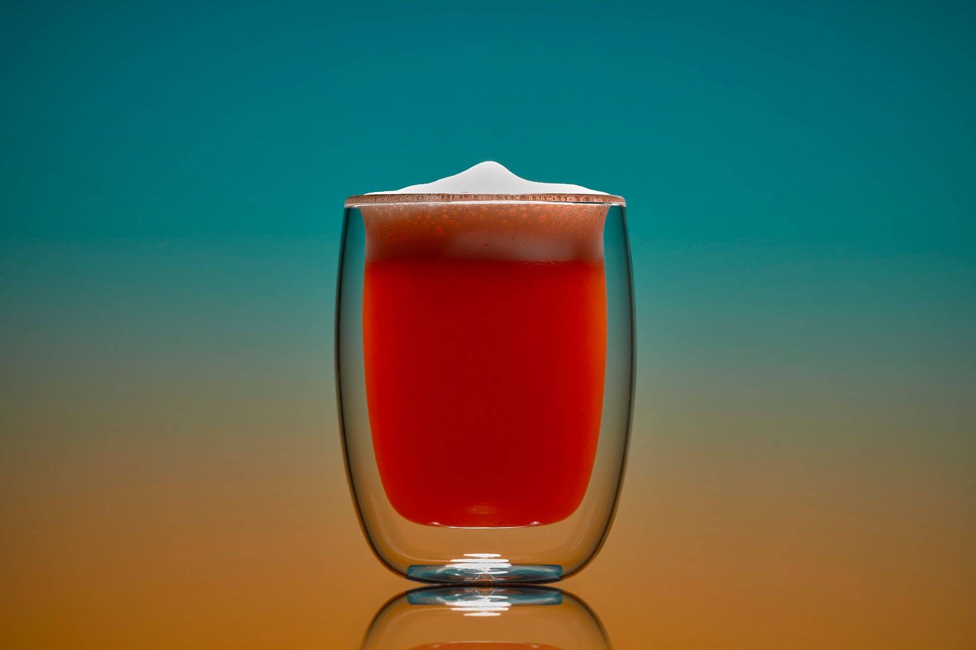 non-alcoholic-grapefruit-fizz-mocktail non-alcoholic grapefruit fizz mocktail on blue and orange background