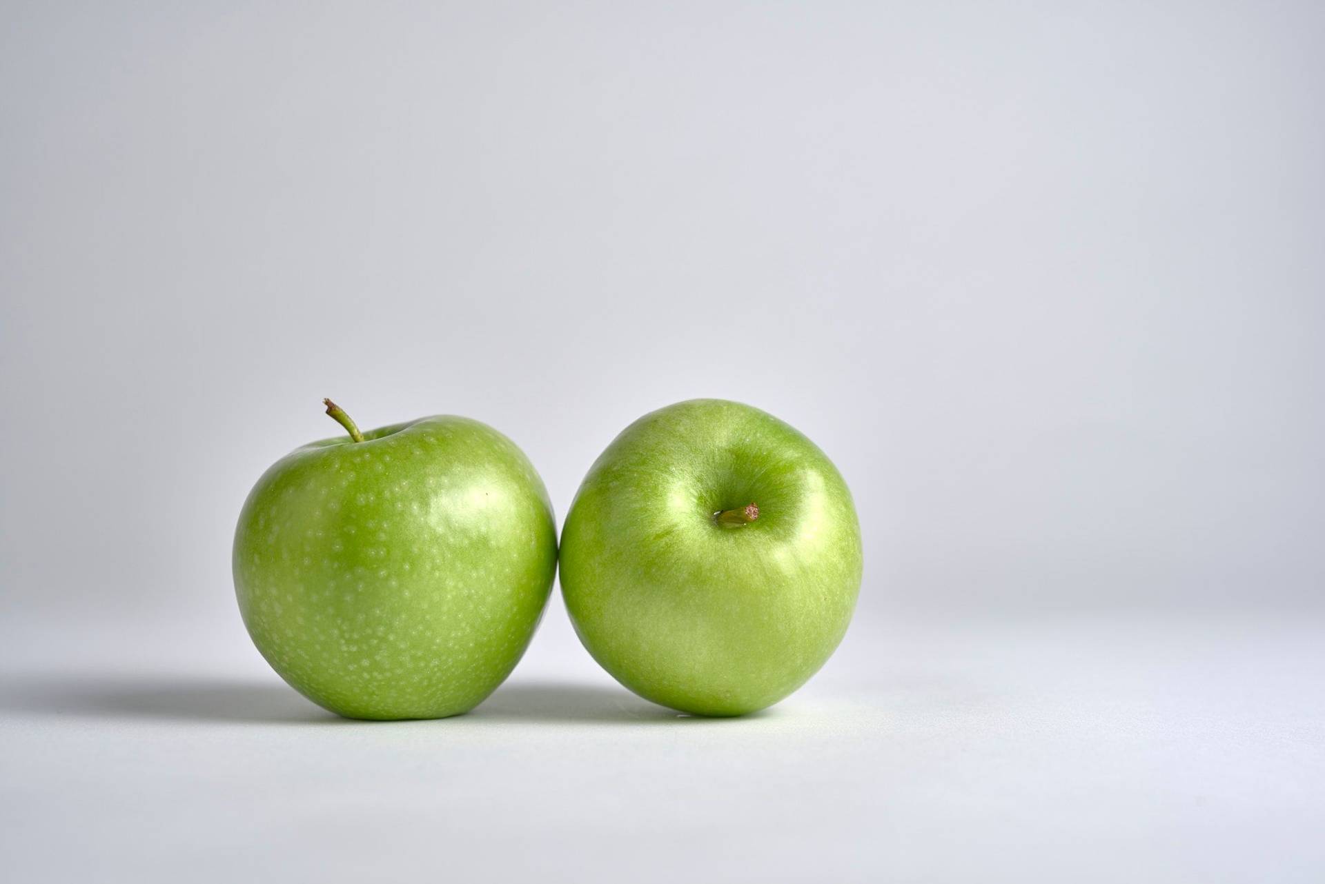 green-apples two green apples with white background