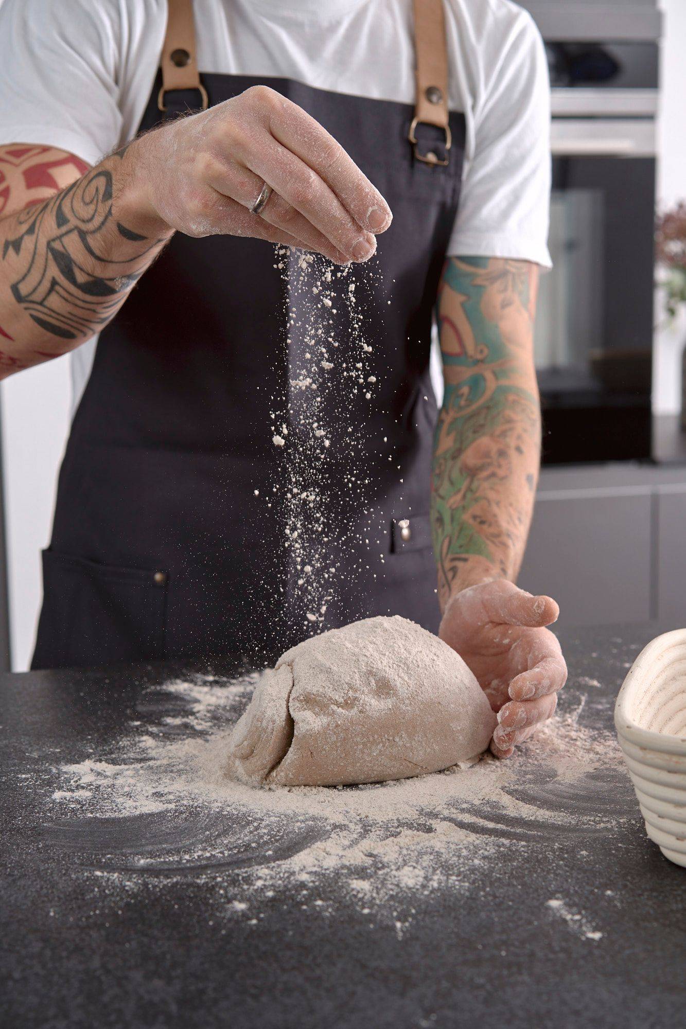 kneading-rye-sourdough man is kneading rye sourdough in home kitchen