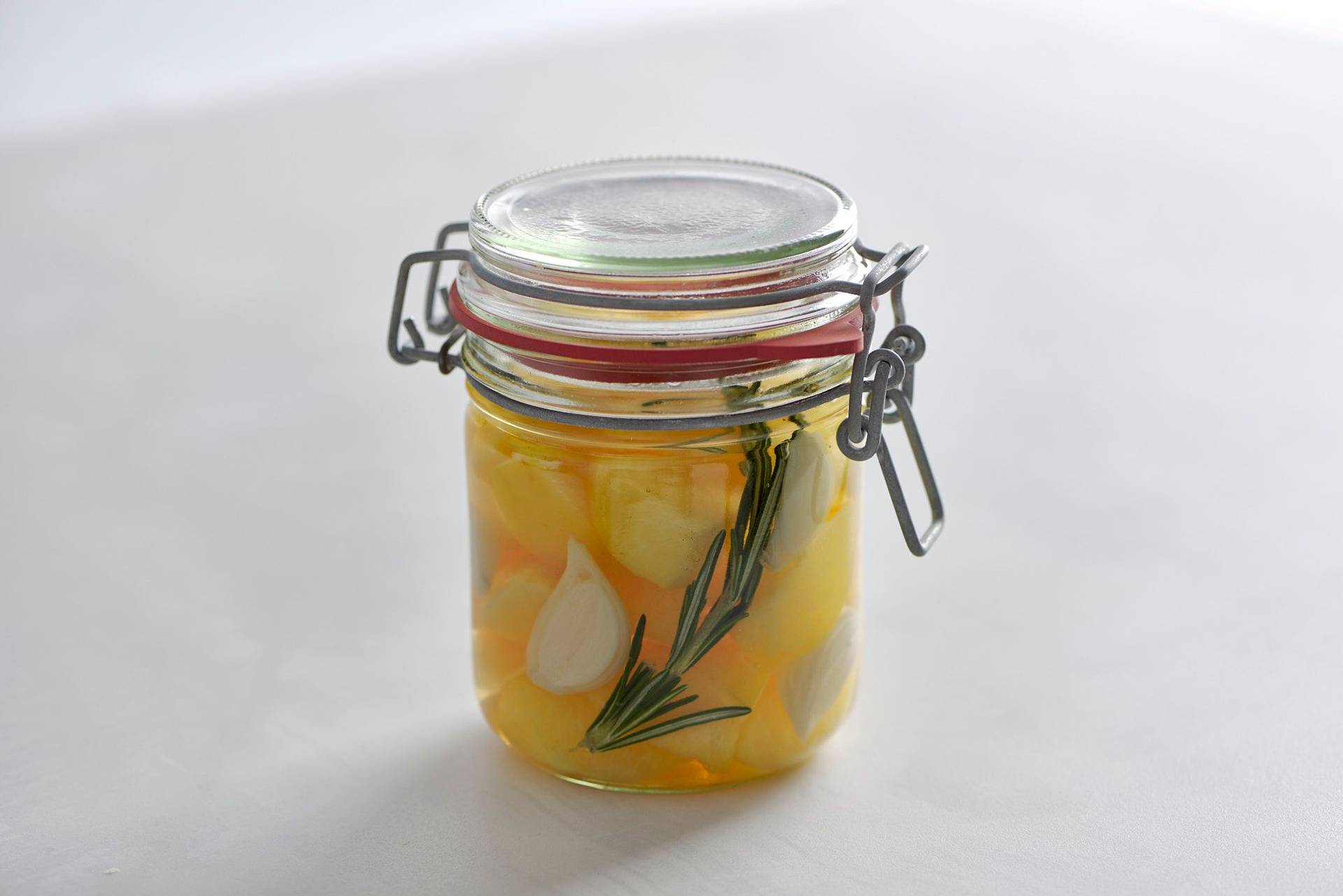 plum-pickles plum pickles in a jar on a white sapienstone top
