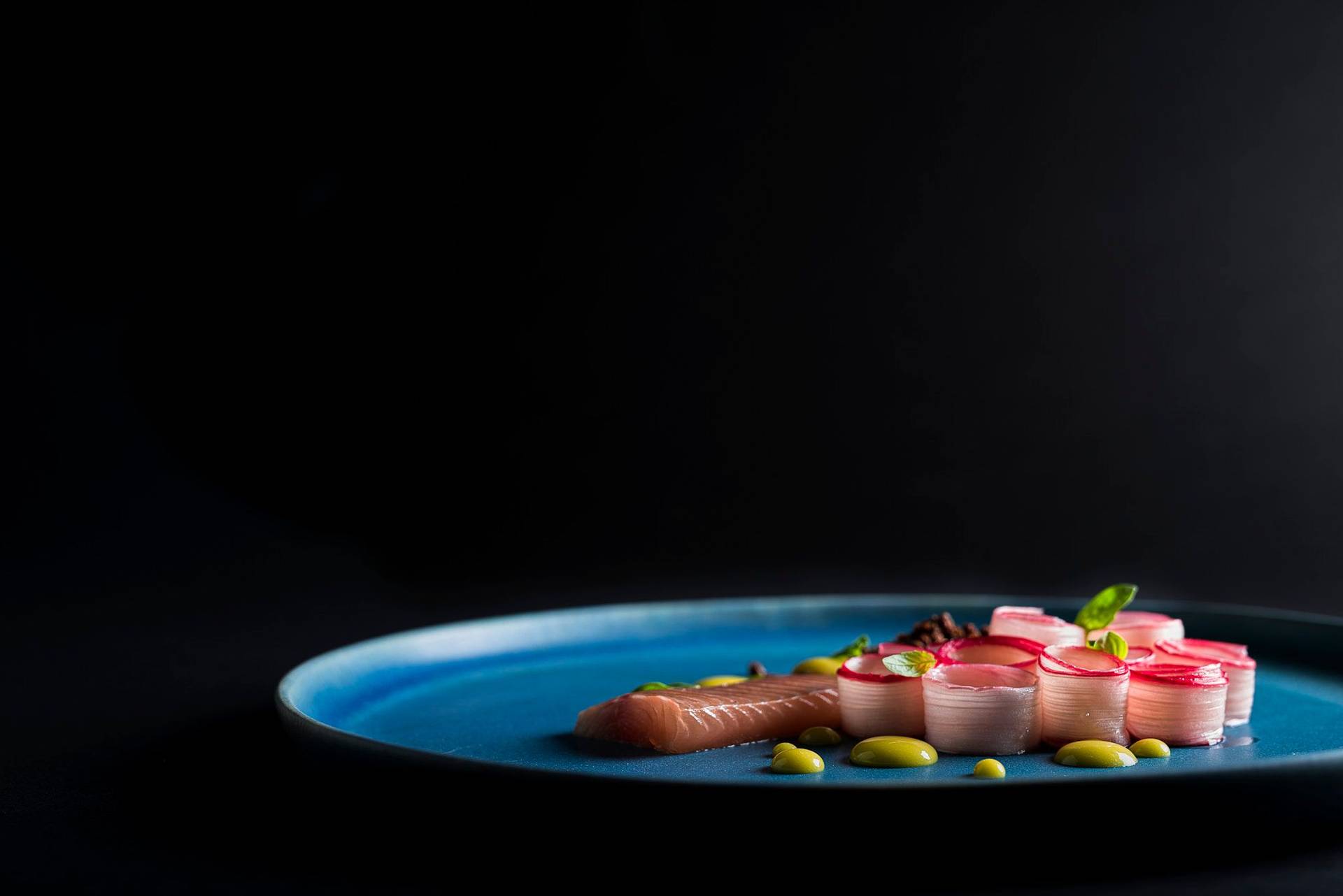 basil-and-orange-cured-char-with-rhubarb-and-tea-mayonnaise basil and orange cured char with rhubarb and tea mayonnaise on a blue plate with black background