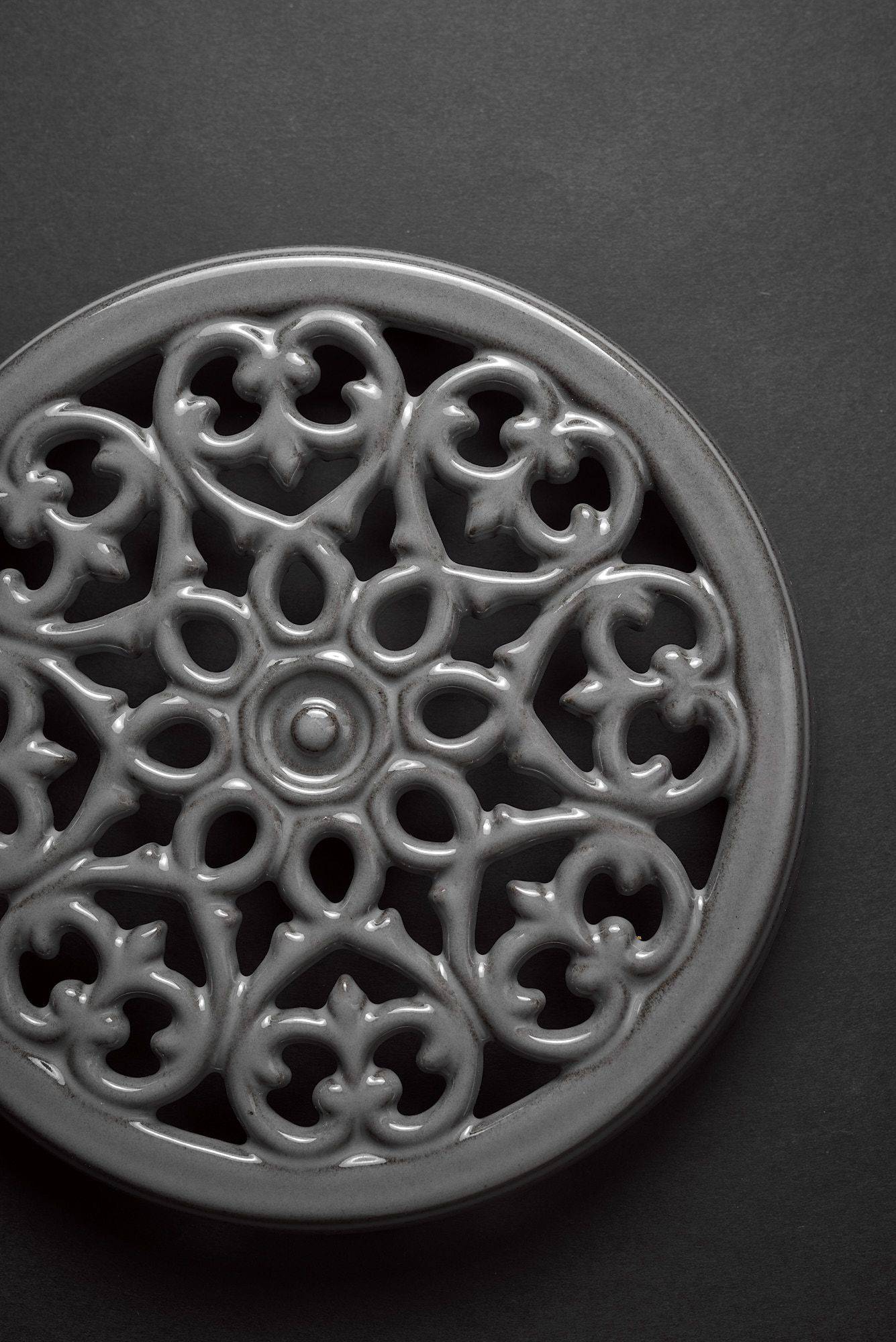 staub-la-cocotte-cast-iron-pots gray staub la cocotte cast iron coaster on black background
