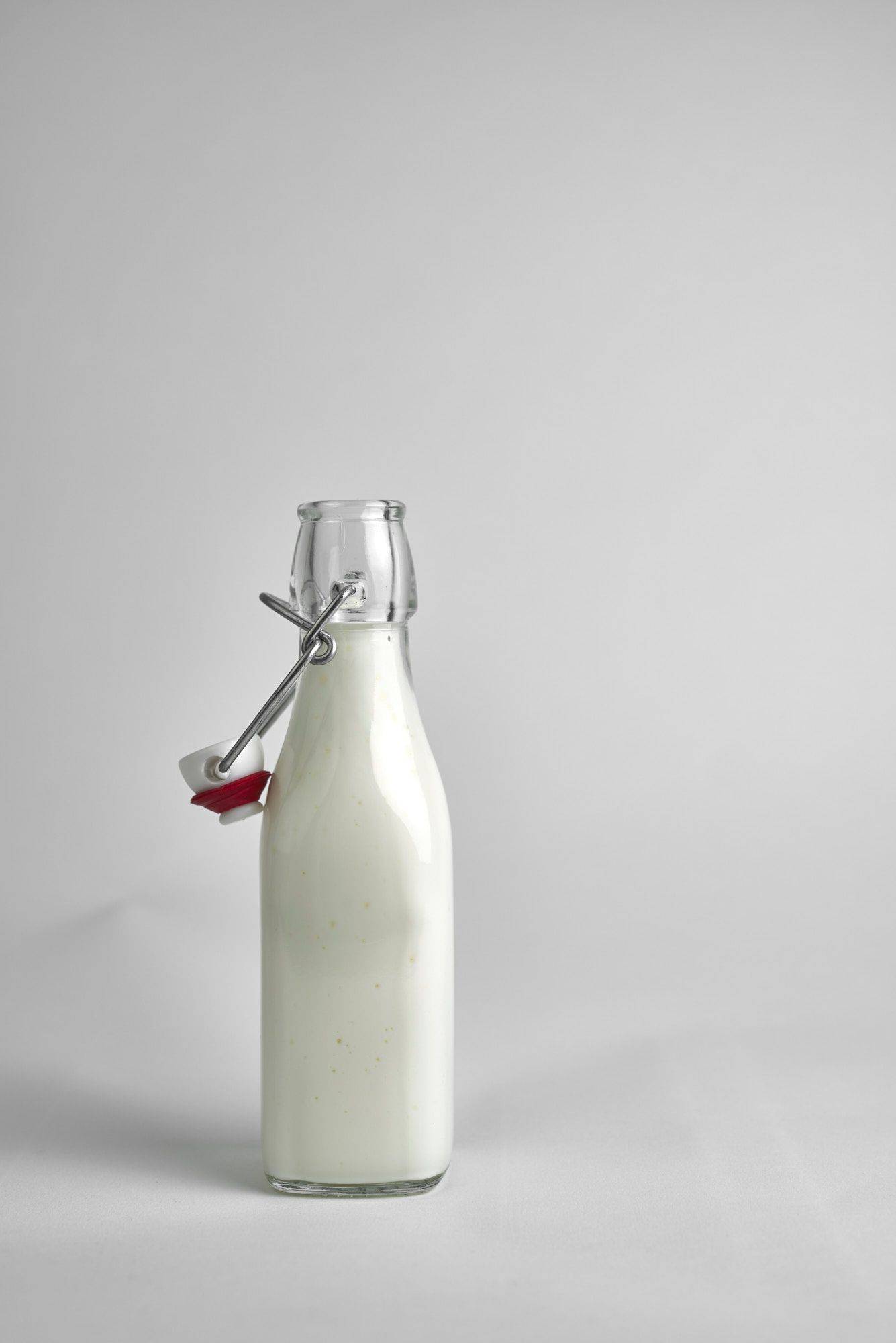 kefir a small glass bottle of kefir on white background