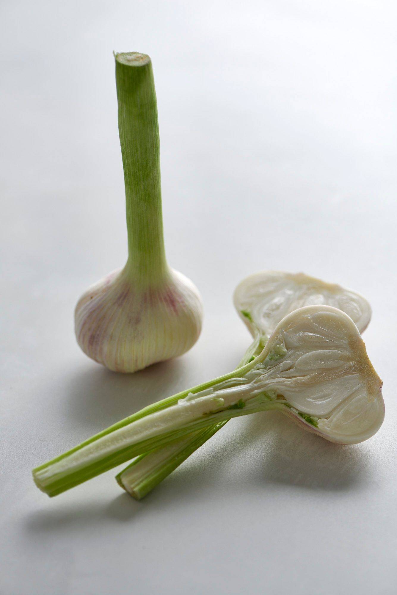 garlic two pieces of garlic on a white sapienstone top