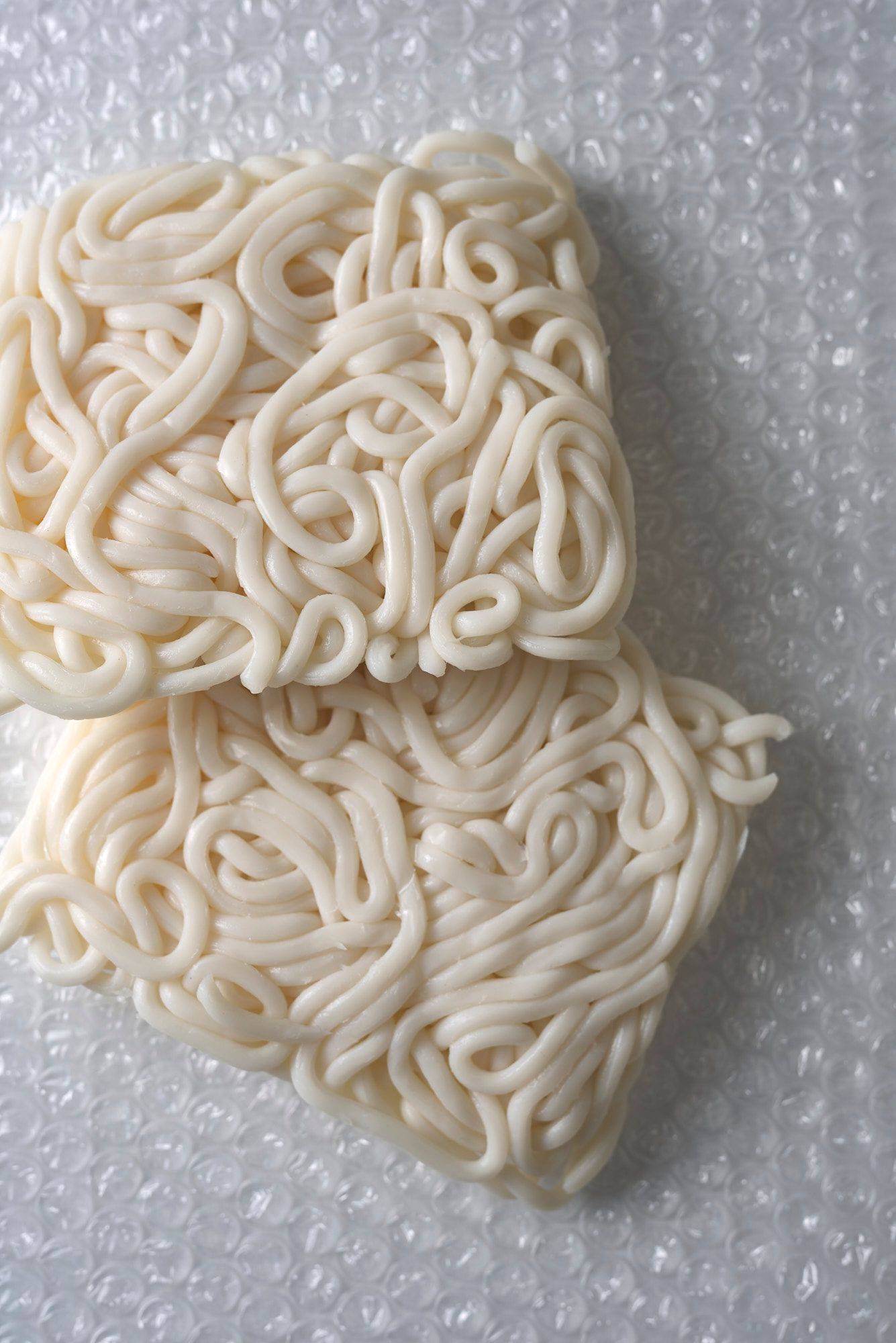 udon-noodles raw udon noodles on plastic foil