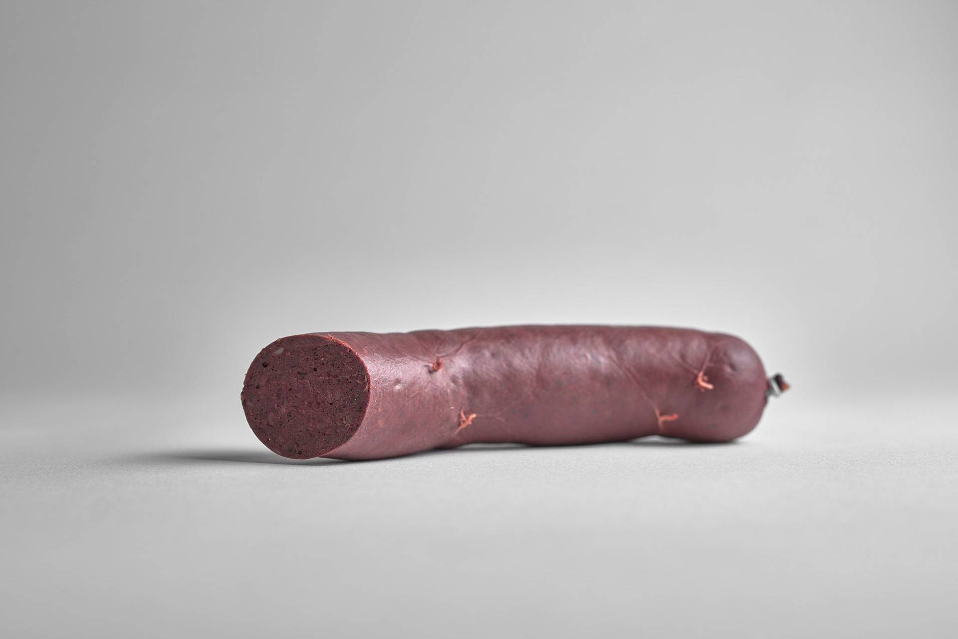 boudin-noir-blood-pudding a sausage of boudin noir blood pudding on white background
