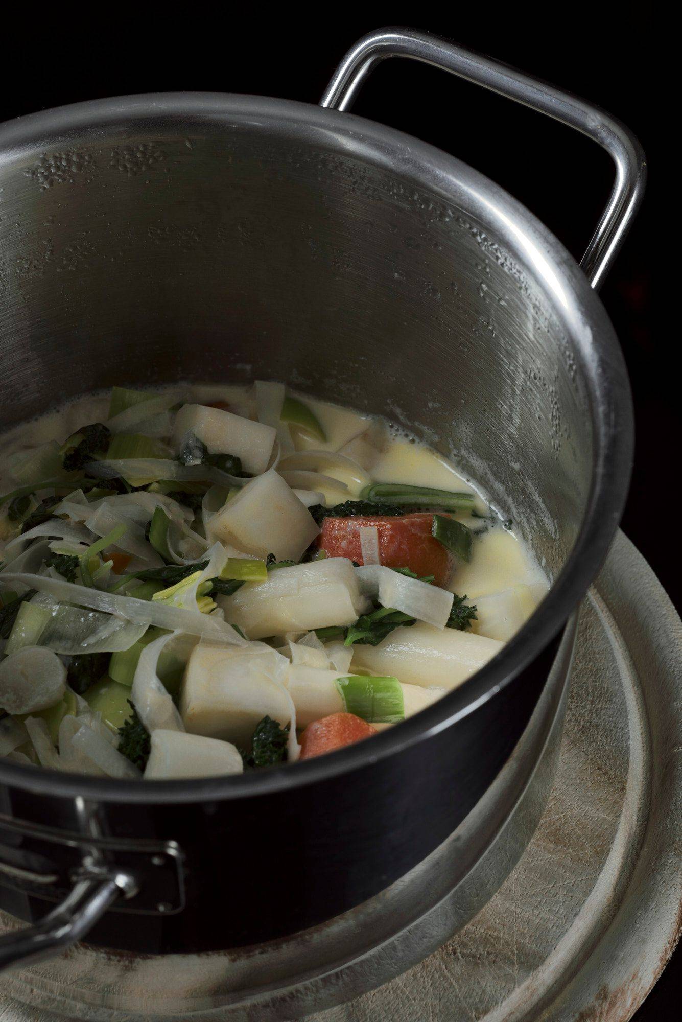 vegetable-basil-sauce vegetable basil sauce in a metal pot with black background