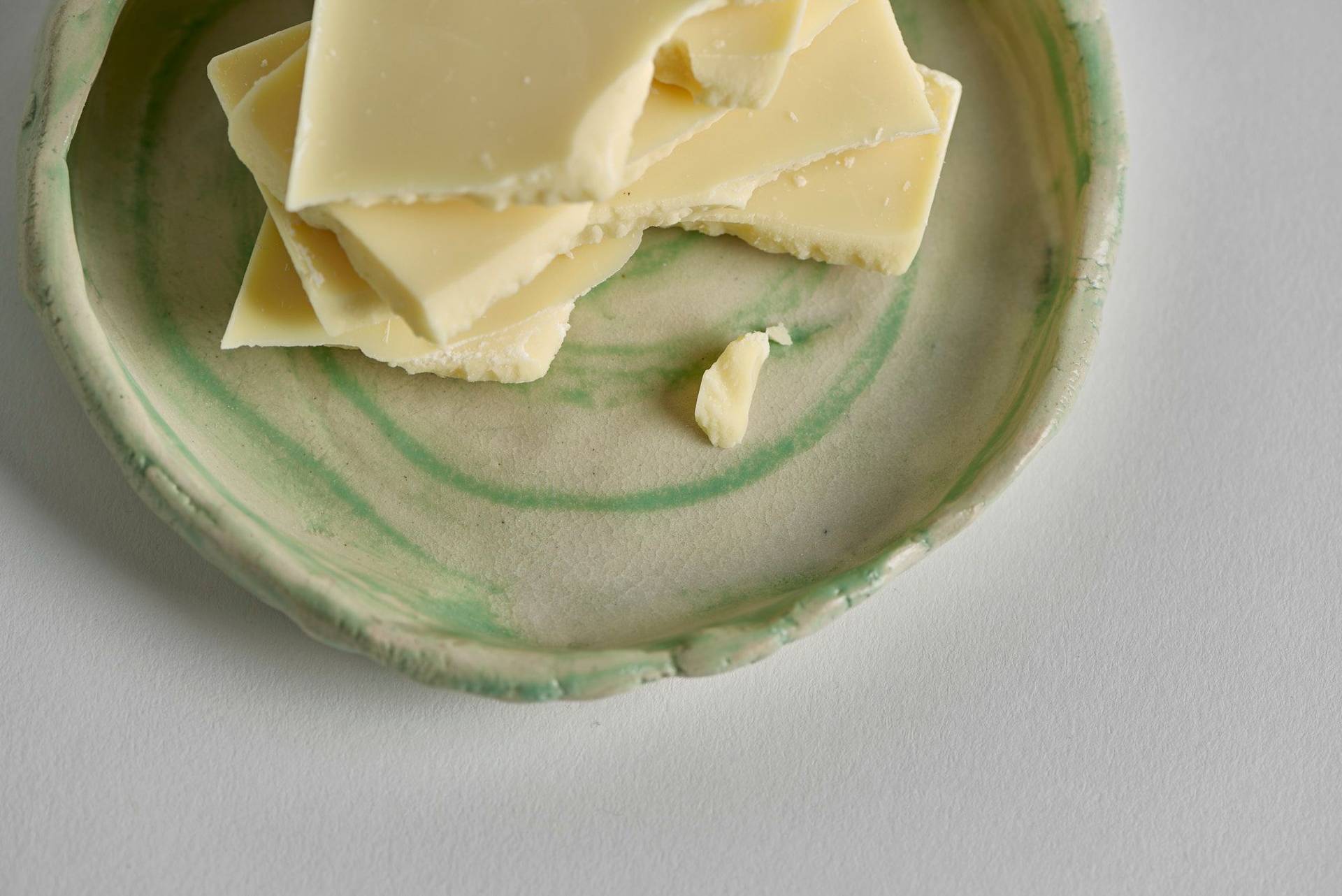 white-chocolate white chocolate on a ceramic plate with white background