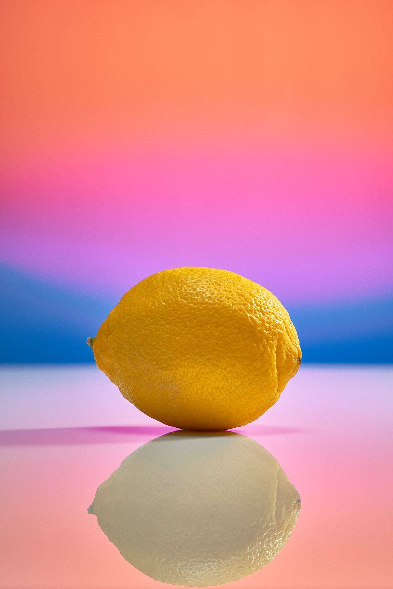fresh-lemon a fresh lemon on rainbow colored background