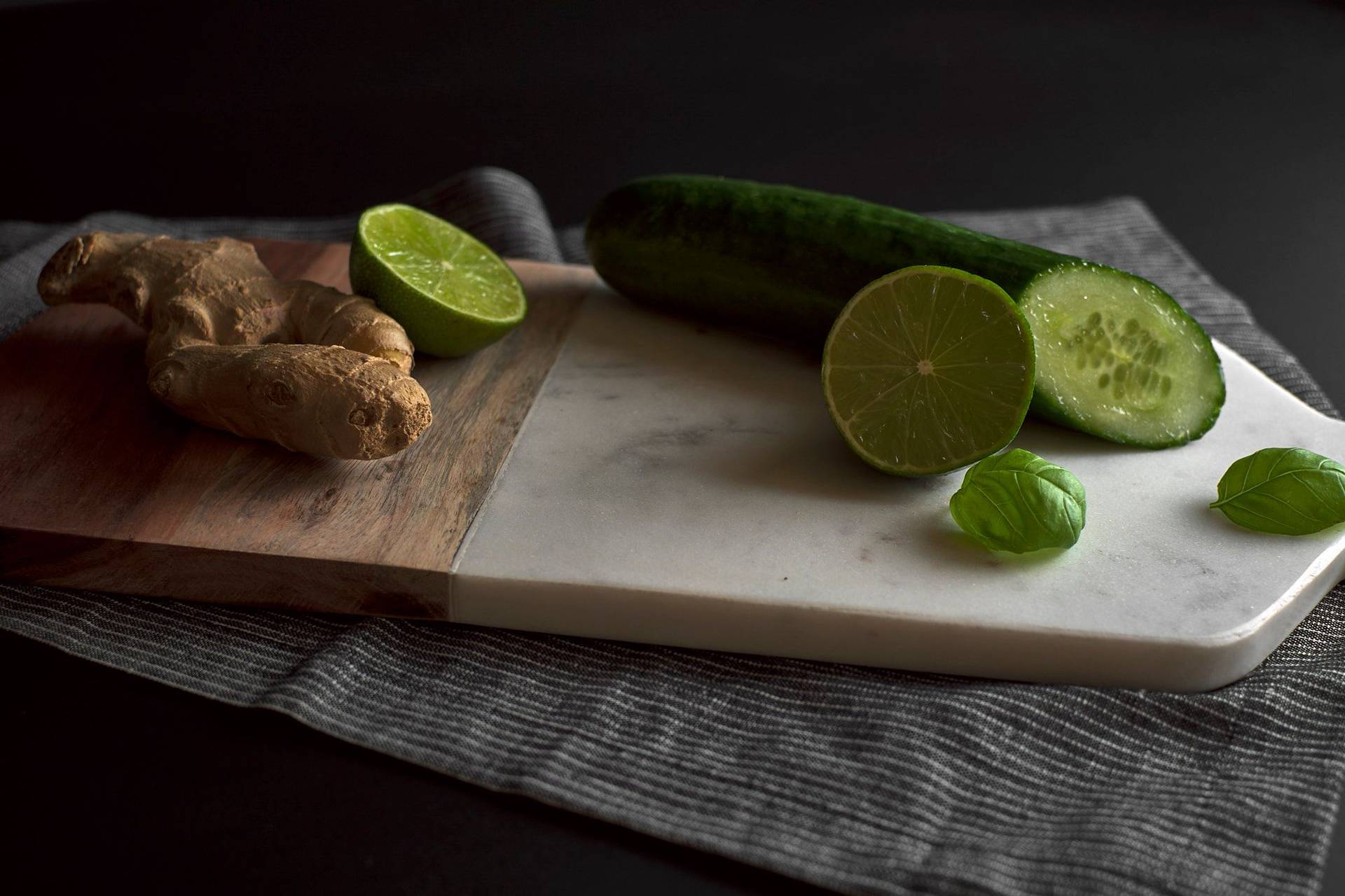 cucumber-ginger-and-basil cucumber, ginger and basil on a marble cutting board with black background