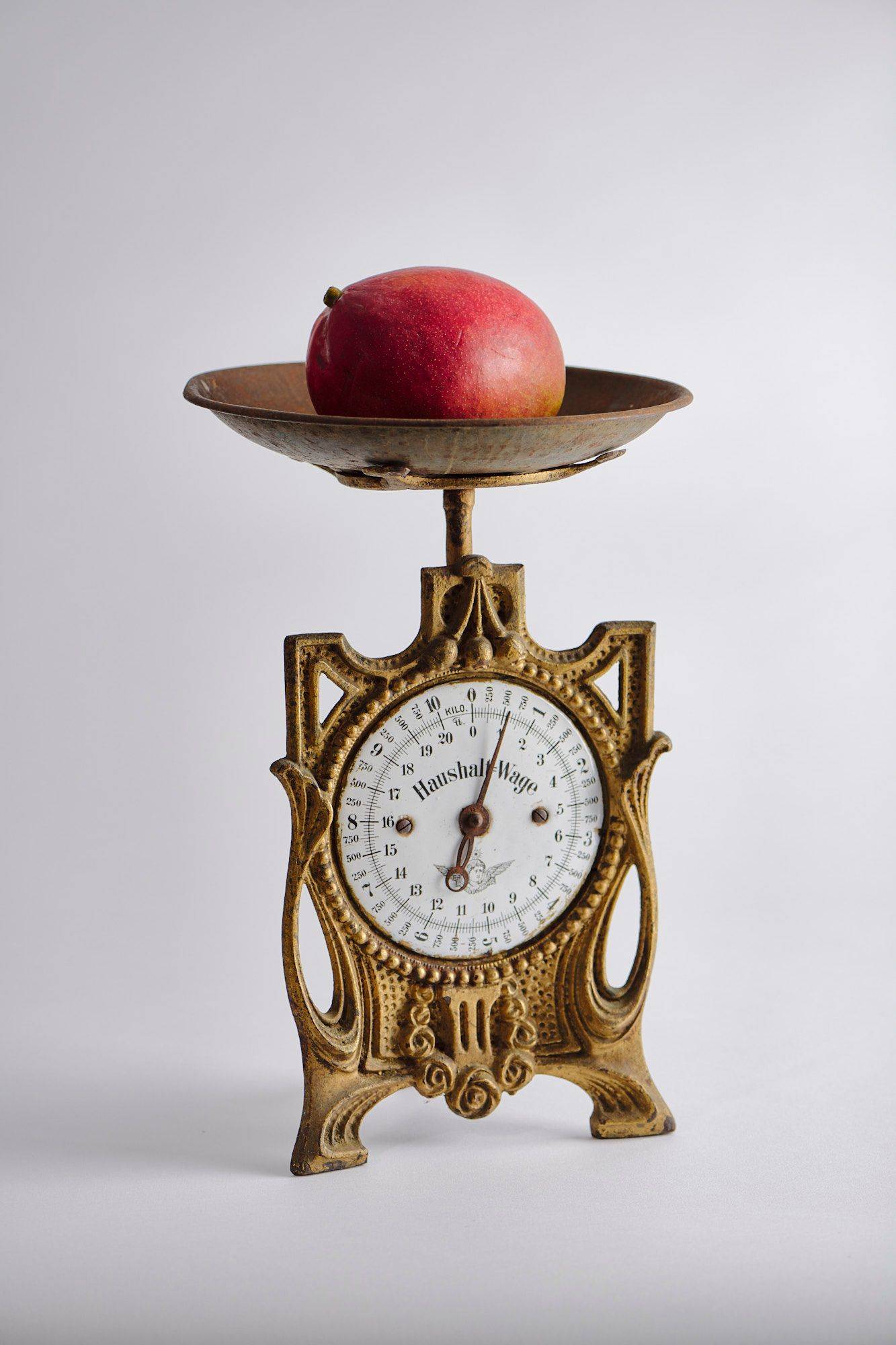 mango a mango on a vintage scale with white background