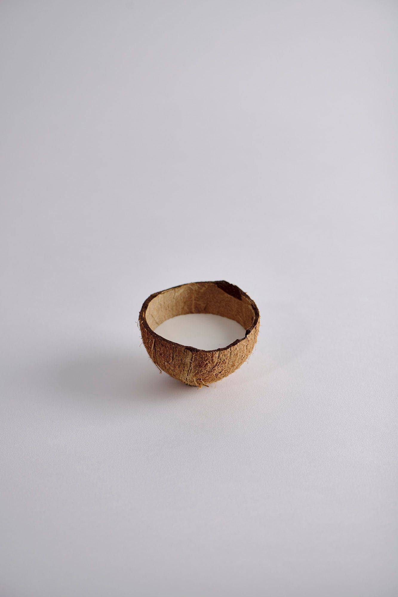 coconut-cream coconut cream in a coconut shell with white background