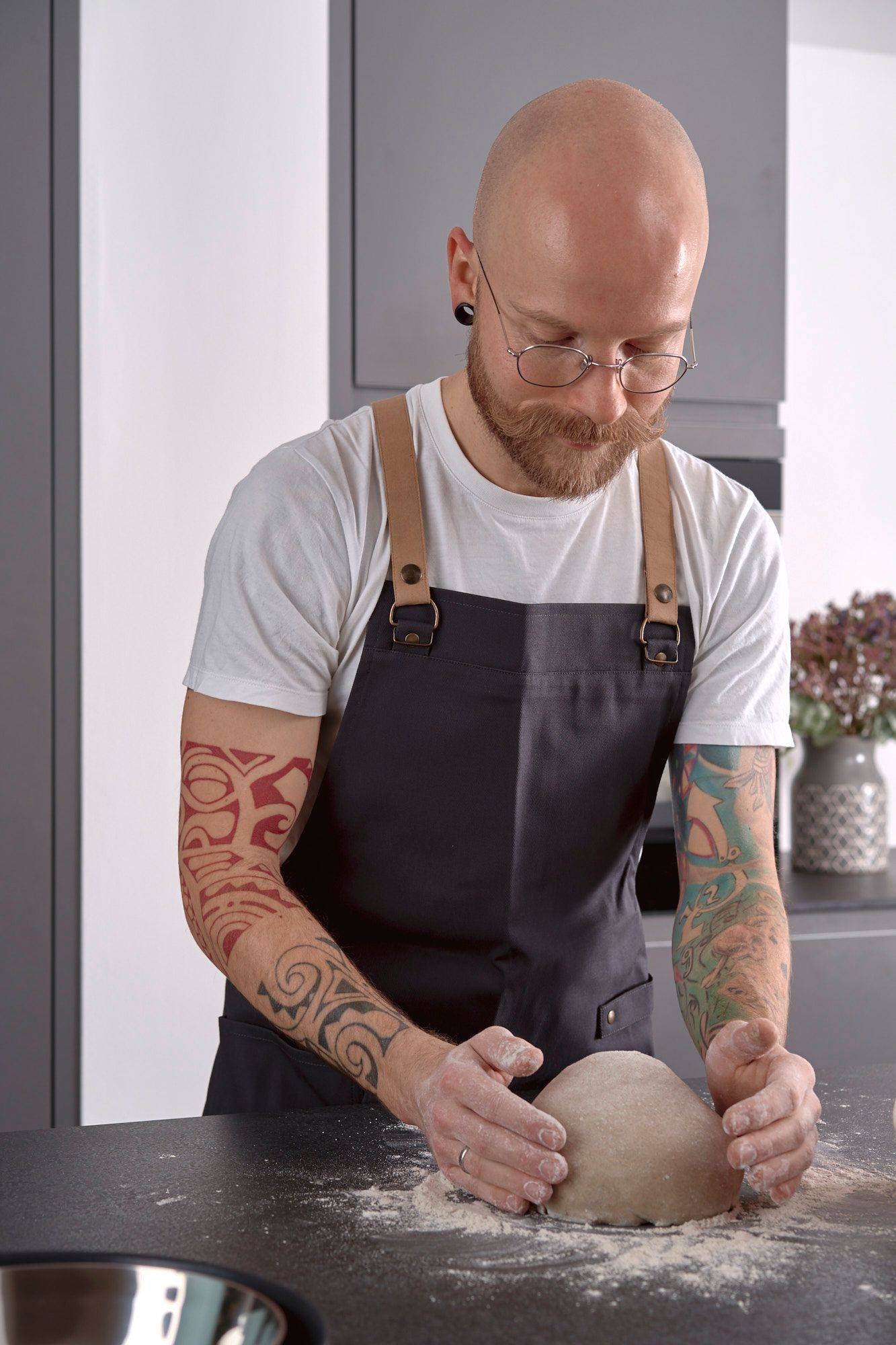 kneading-rye-sourdough man is kneading rye sourdough in home kitchen