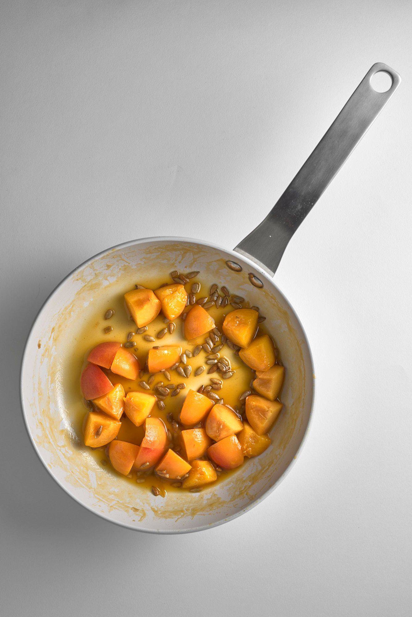 caramelized-apricots caramelized apricots with sunflower seeds on white background