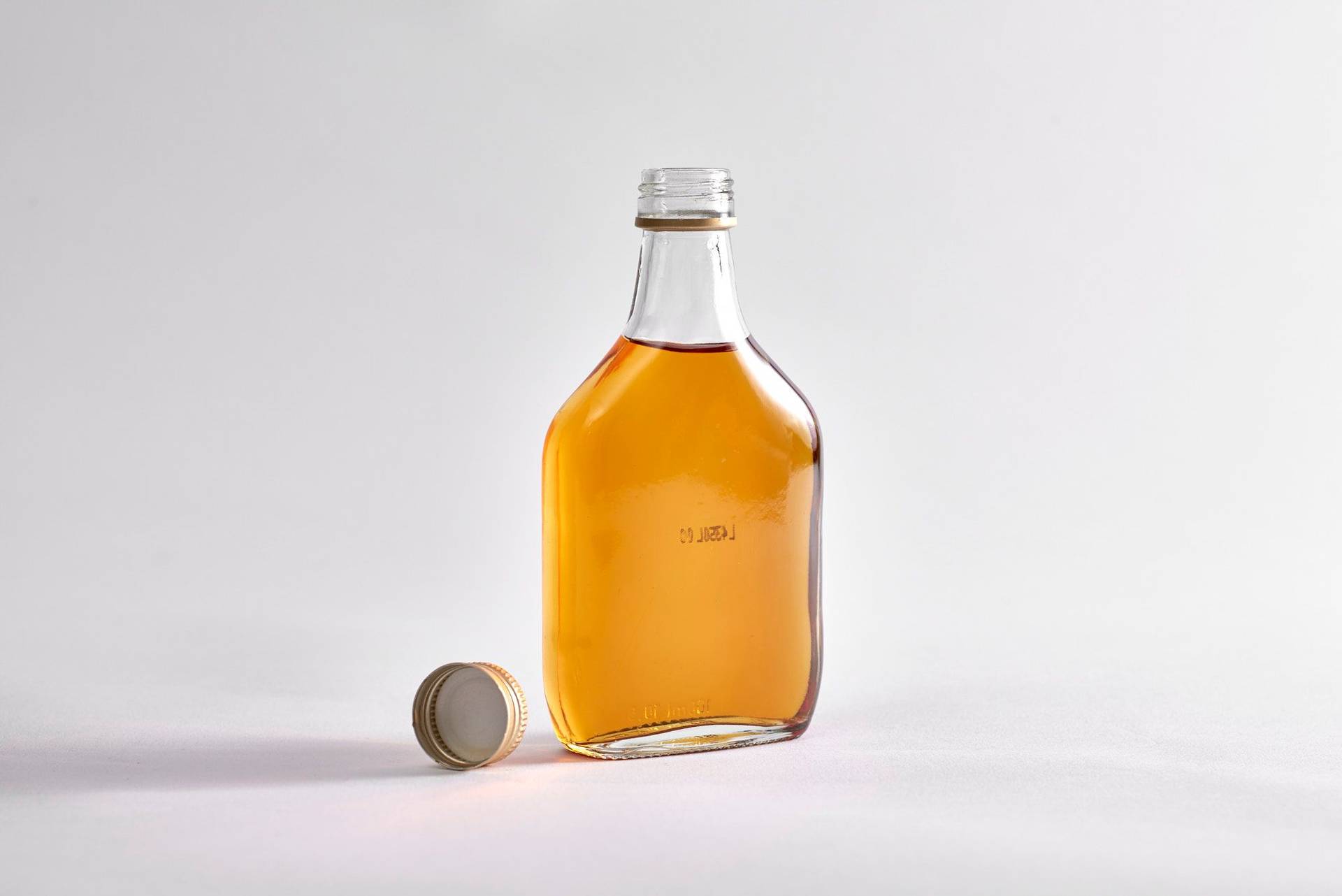 rum a small bottle of rum on white background
